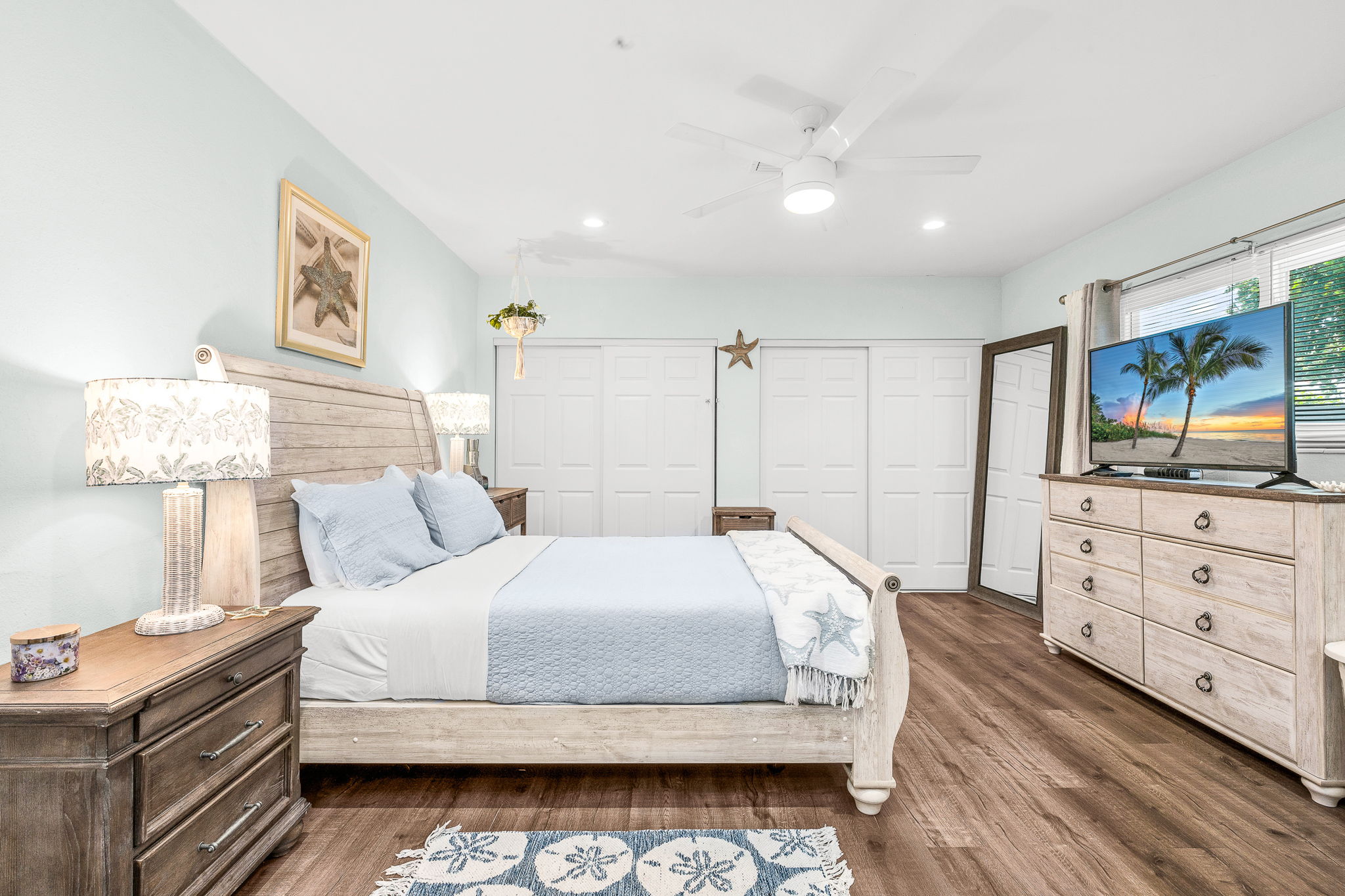 Spacious and peaceful master suite featuring a plush king bed, soft linens and elegant coastal decor.  Offering a cozy reading nook, and a calming palette - your private retreat for rest and relaxation.
