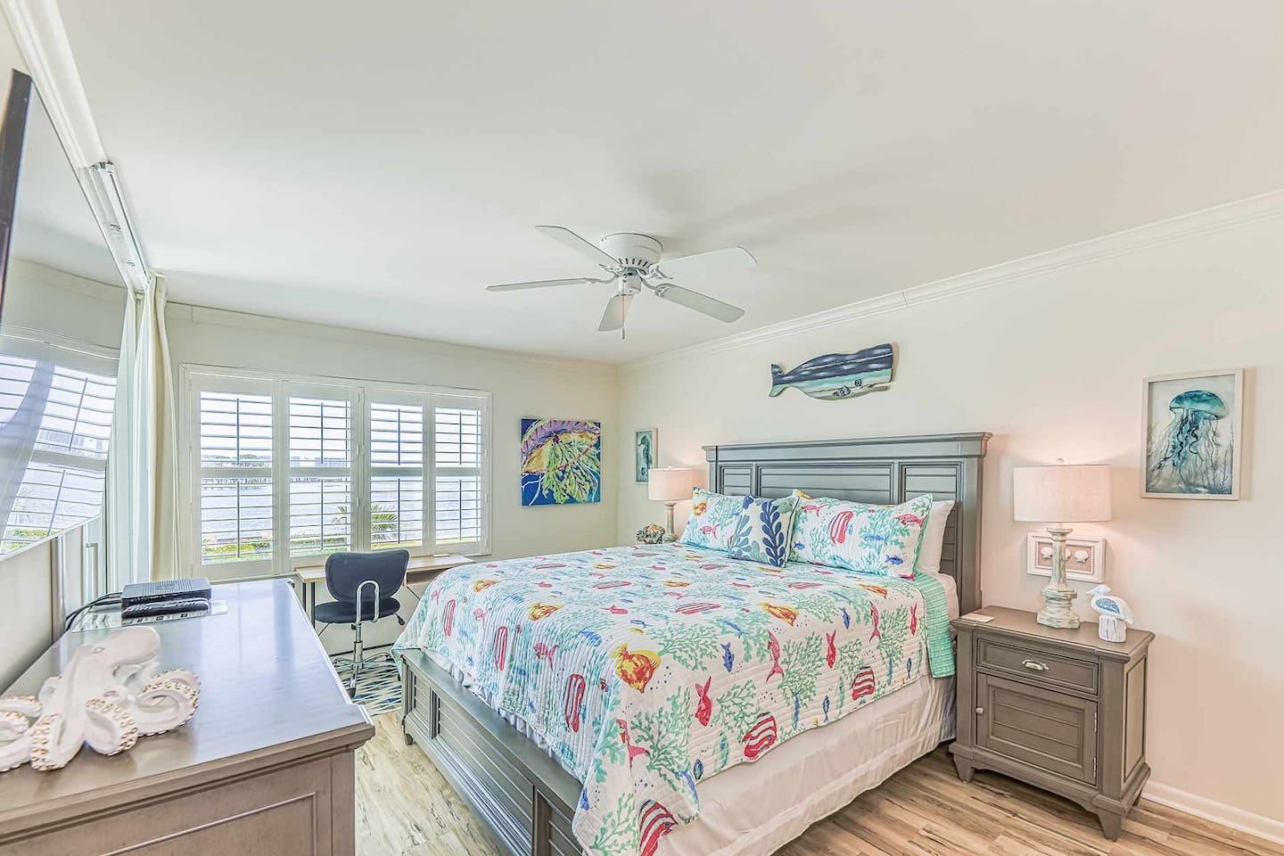 Master Bedroom: Relax in this airy retreat with tranquil bay views and vibrant coastal decor!