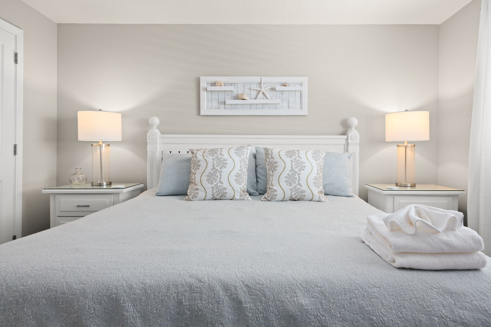 King-size bed centered under soft lighting for a peaceful night’s rest.
