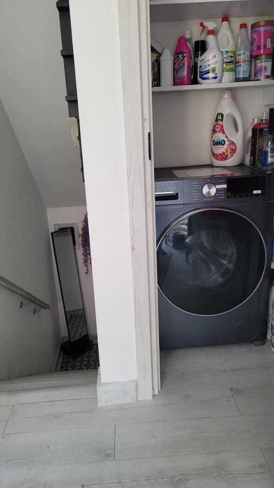 Full size washing machine in the common area shared with downstairs apartment