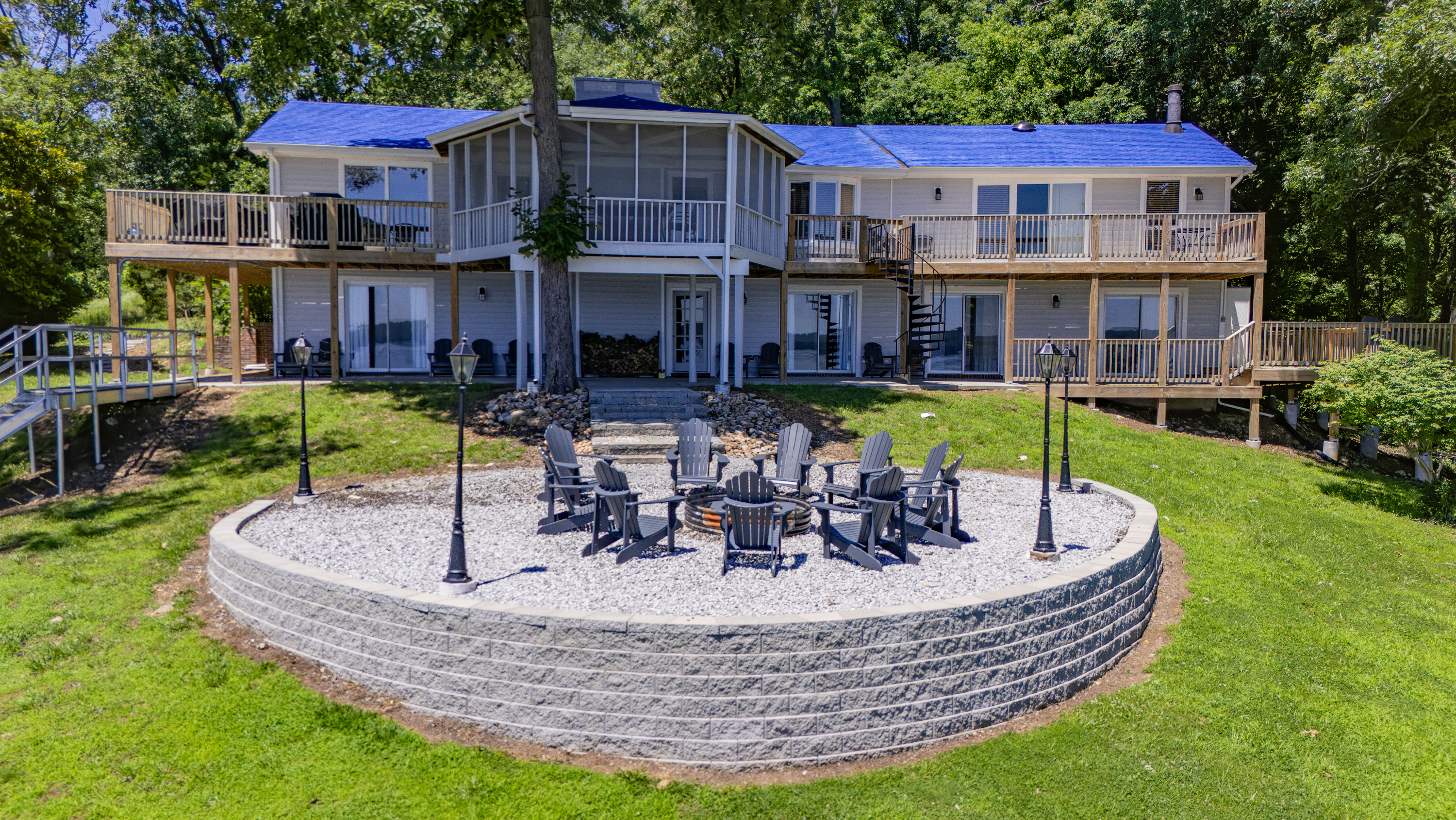 A close aerial captures The View’s expansive lake-facing exterior and large circular firepit gathering area.