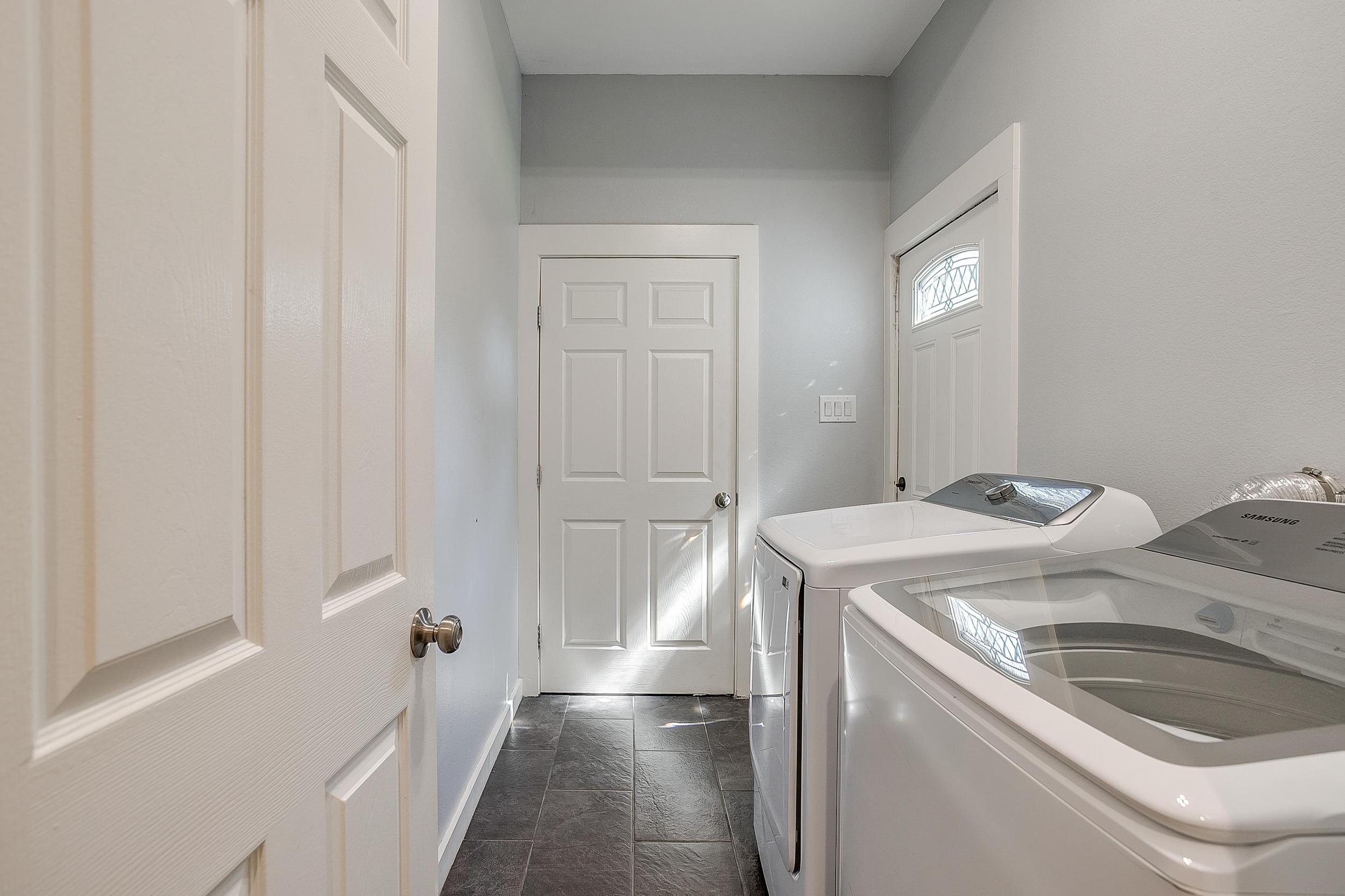 Laundry room with full-size washer and dryer—perfect for longer stays.