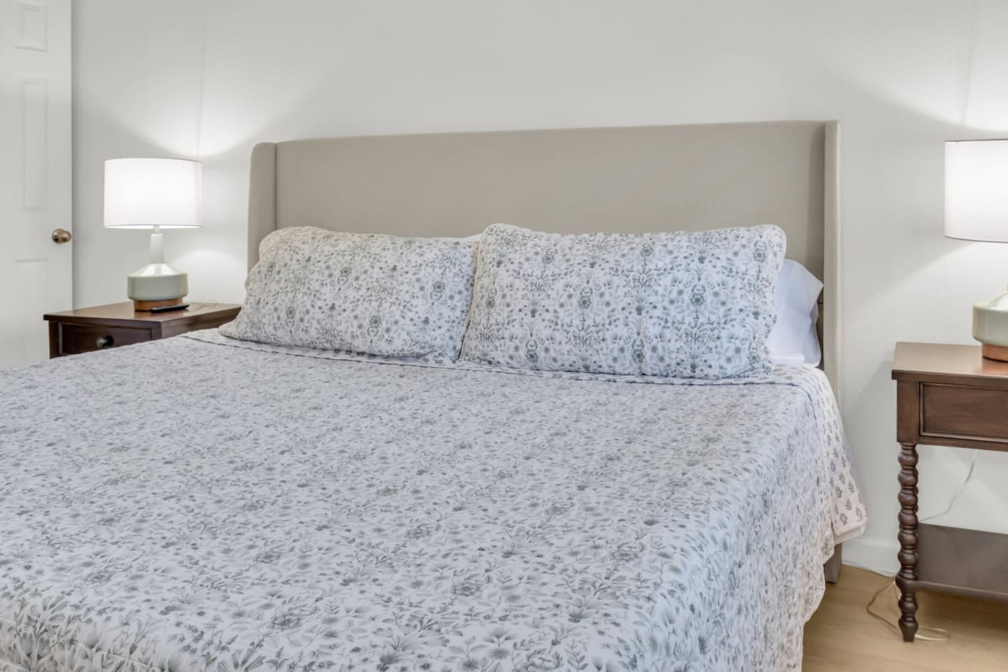 Cozy king bed with fresh bed linens and serene décor. Designed for restful nights and extended stays.