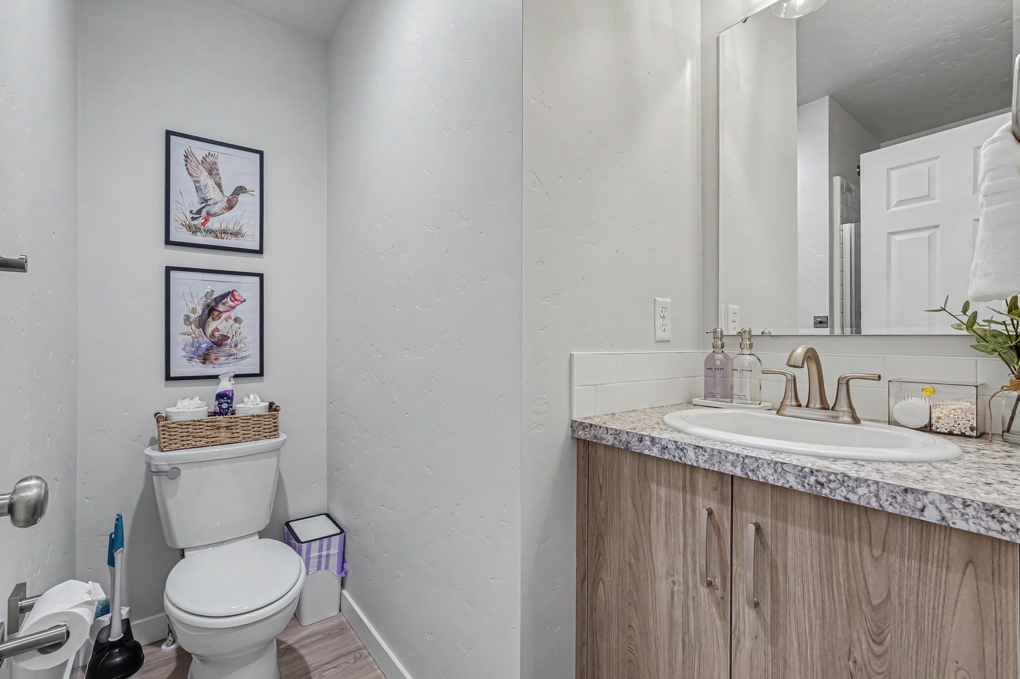 Enjoy the convenience of a full downstairs bathroom with a stand-up shower (not pictured), perfect for added comfort during your stay.