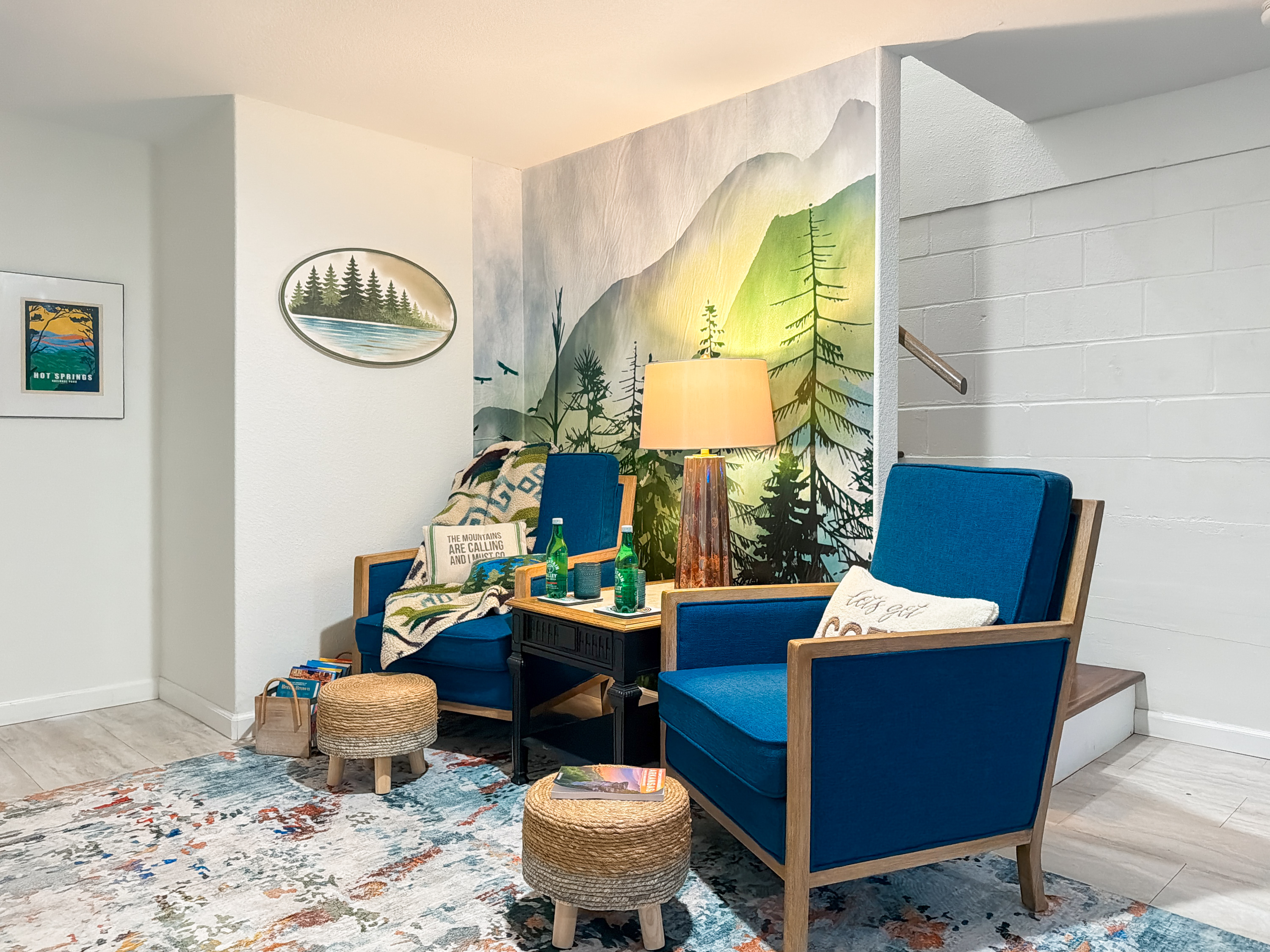 Curl into the reading nook by the forest mural — a screen-free corner for coffee and a slow morning.