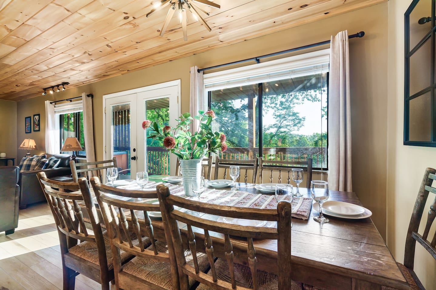 Dining area is on the main level and open to the kitchen and main living room. A brand new dining table with live edge and seating for 10 has replaced the table pictured. Easy access to the propane grill on the mid level porch.