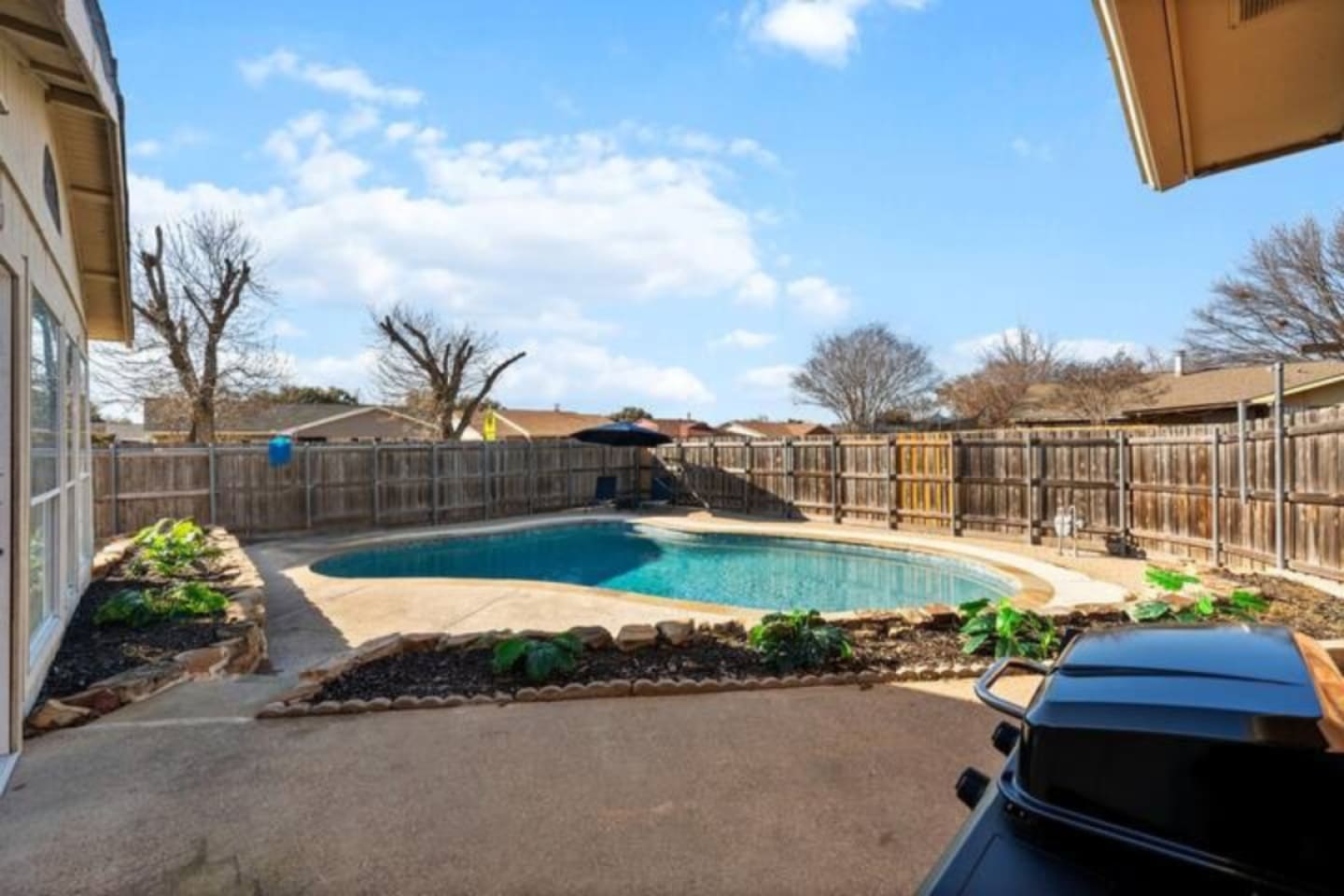 Private backyard oasis with sparkling pool, sun loungers, and direct access to the indoor bar—perfect for poolside entertaining.