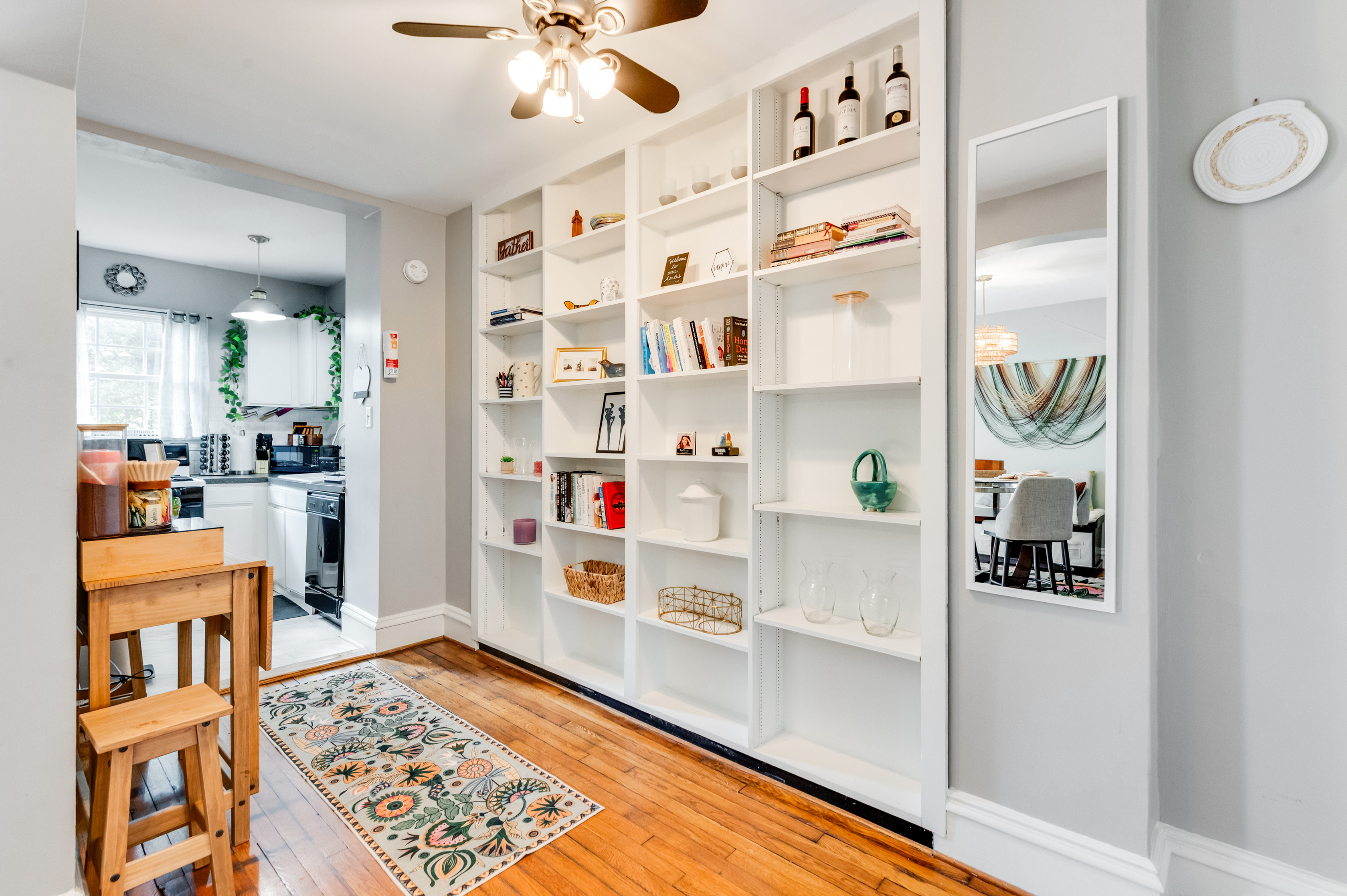 Living Space: Inviting nook with stylish decor, natural light, and a charming bookshelf!