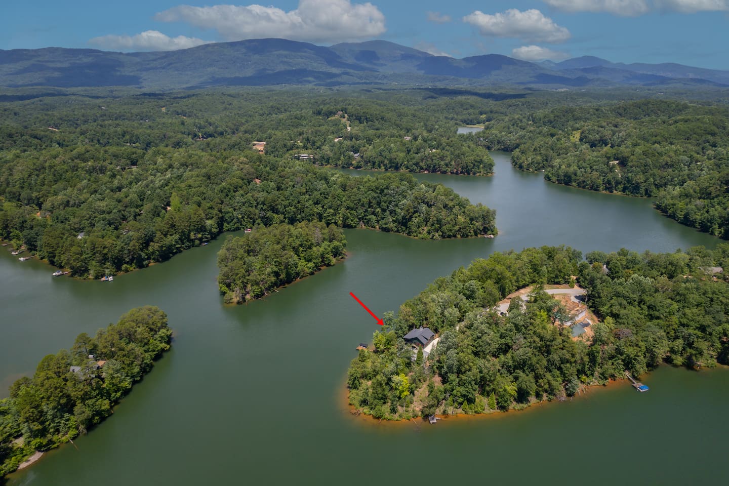 Where the lake house sits surrounded by lake and mountain beauty