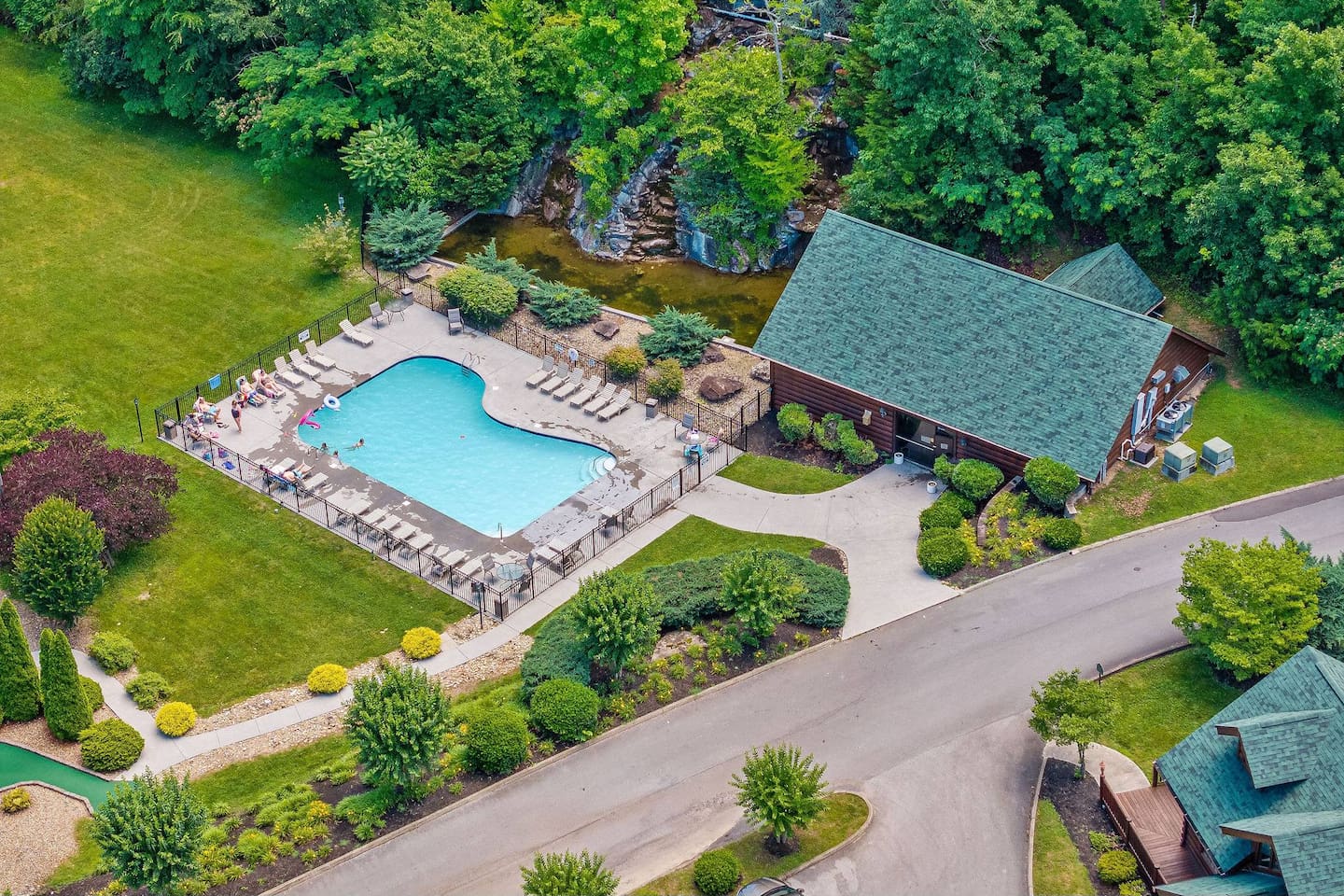 Outdoor pool to the left, indoor heated pool in the building on the right.