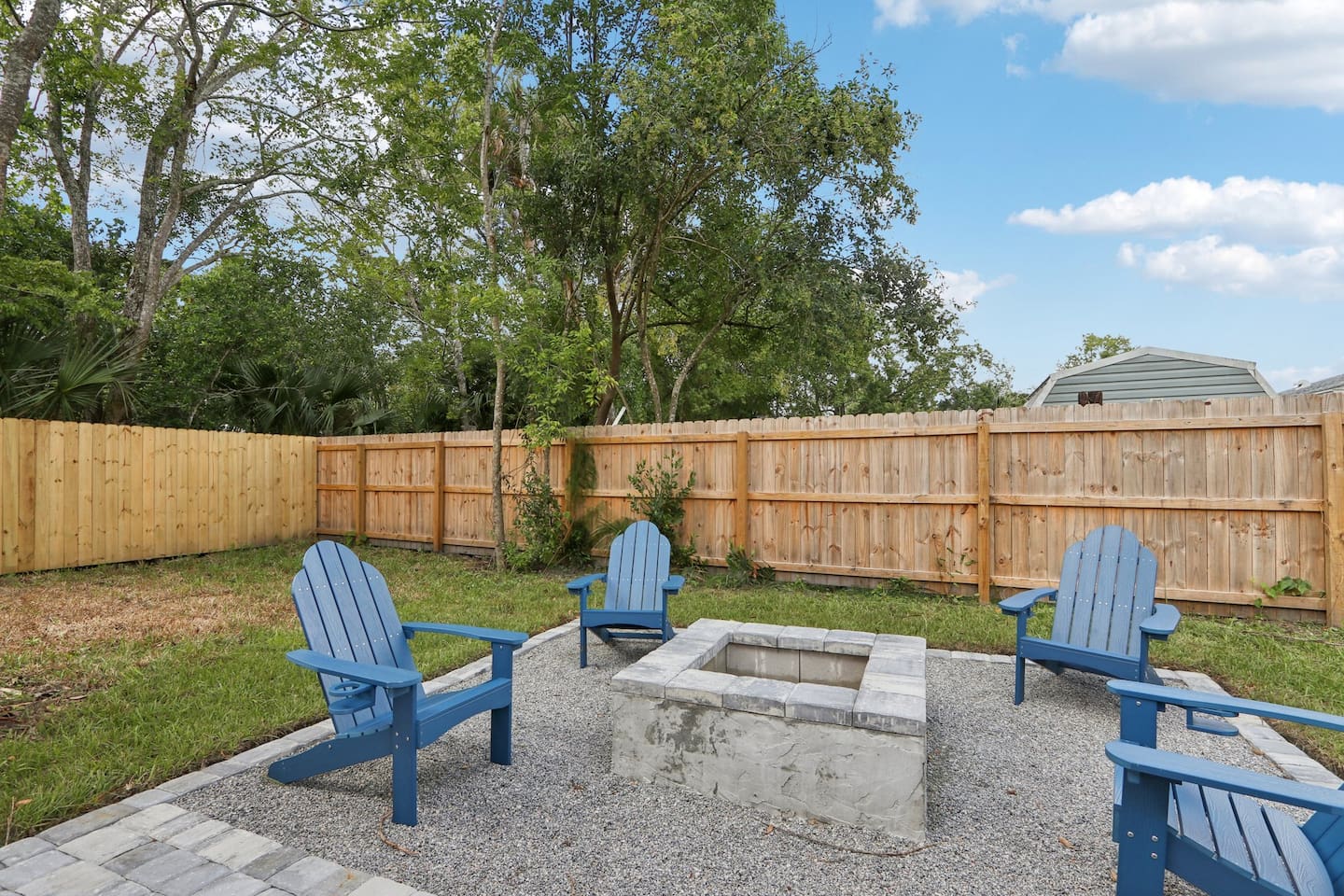Outdoor firepit with 4 Adirondack chairs, BBQ grill, and outdoor picnic table