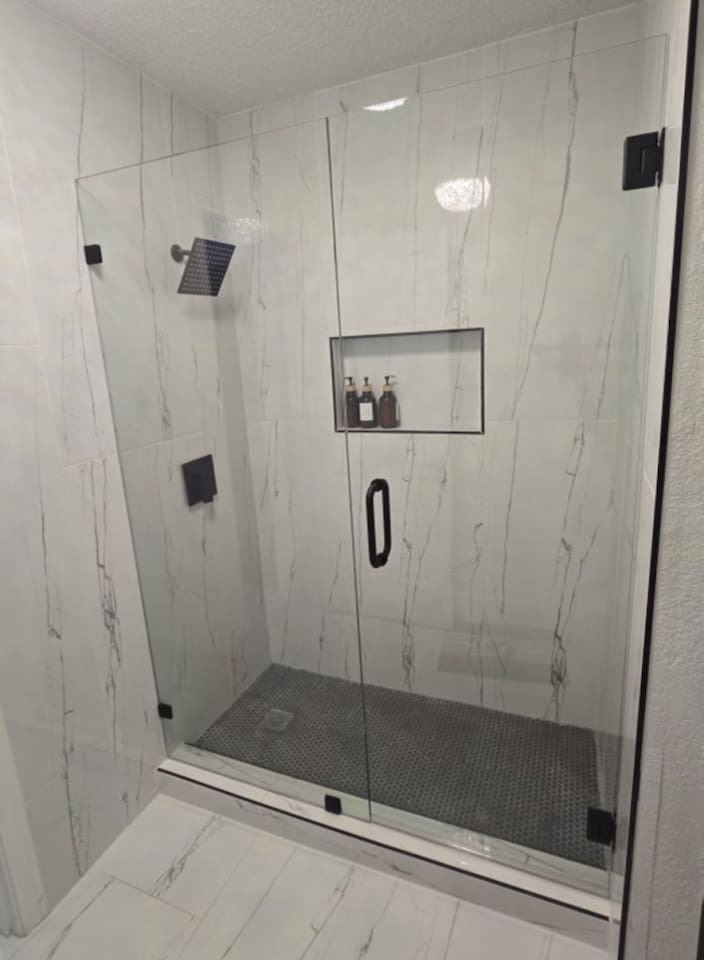 Experience a newly renovated spa-style walk-in shower featuring a luxurious rainfall head, elegant tile finishes, and premium shampoo, conditioner, and body wash—all the essentials for a refreshing, hotel-quality stay. Perfect blend of modern comfort