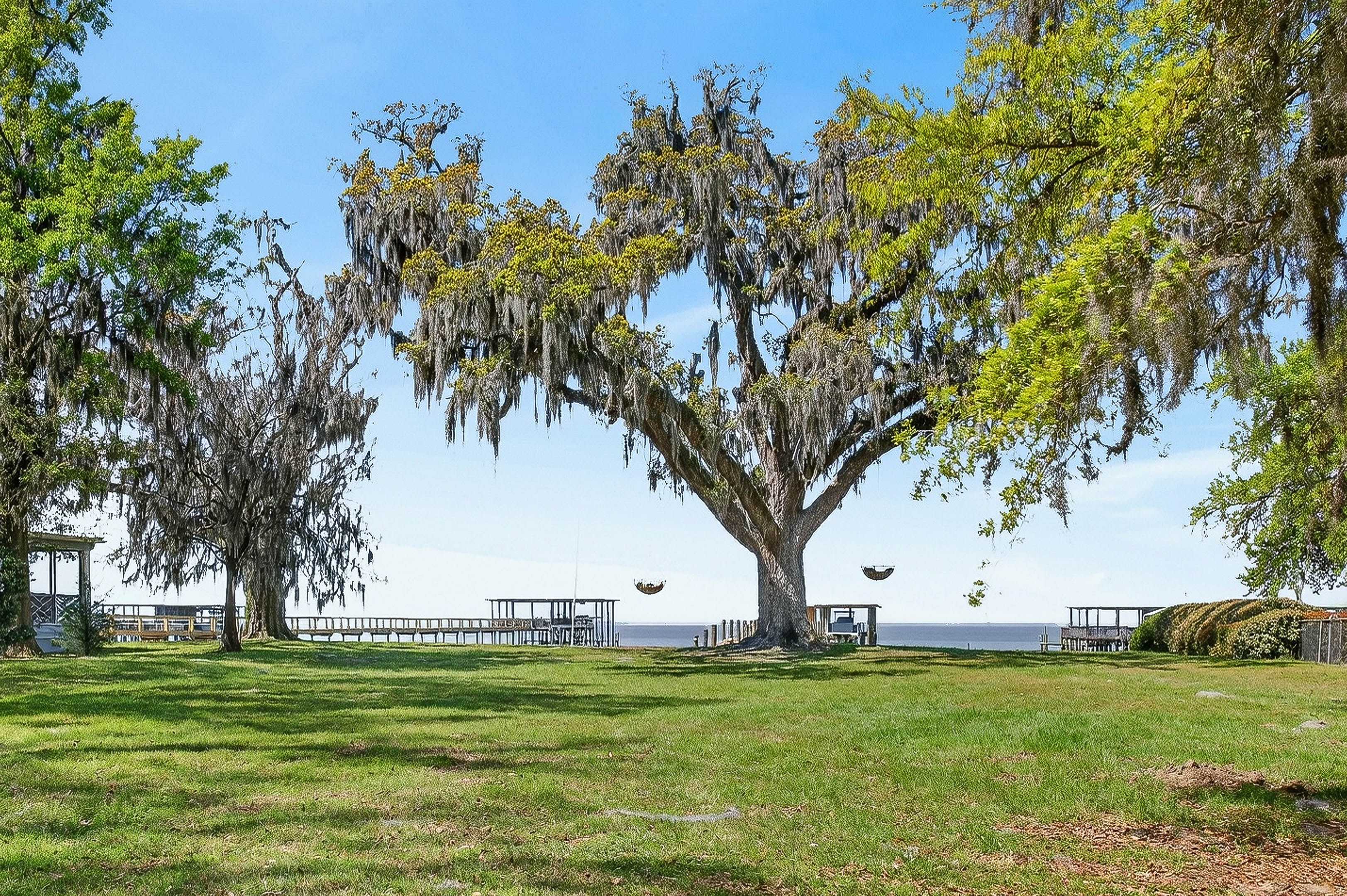 Expansive backyard with direct access to the private dock and bay beyond