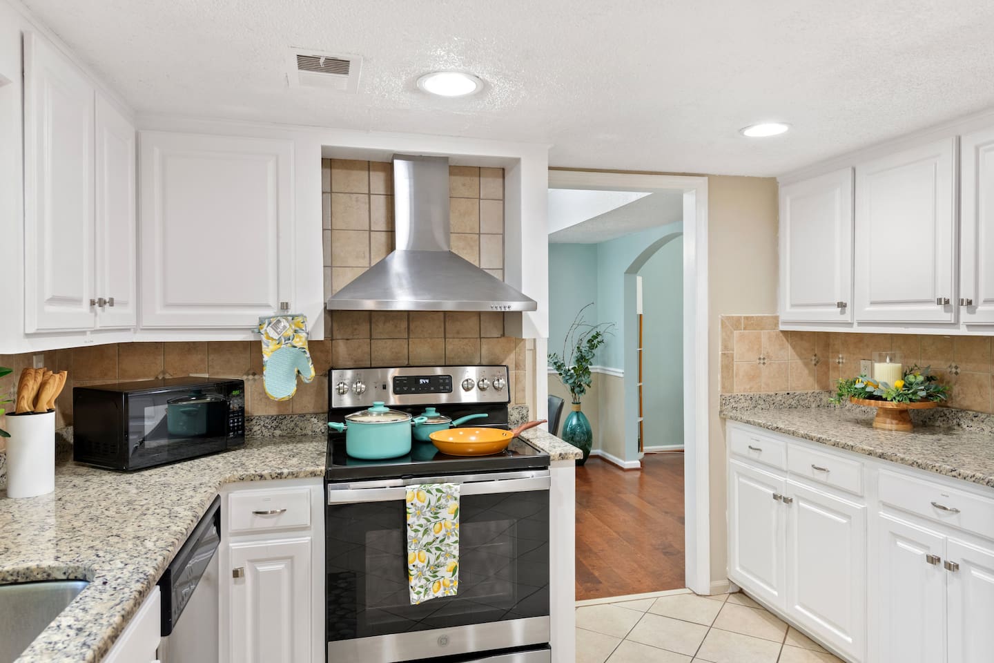 Bright and functional, this kitchen features granite countertops, stainless appliances, and all the essentials for cooking or entertaining. 