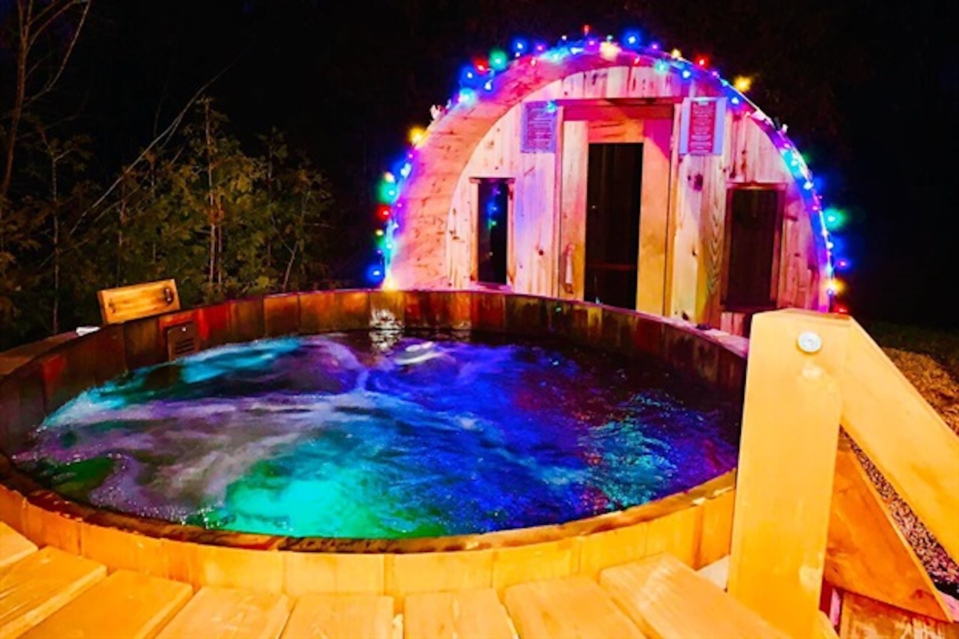 Private outdoor hot tub illuminated at night