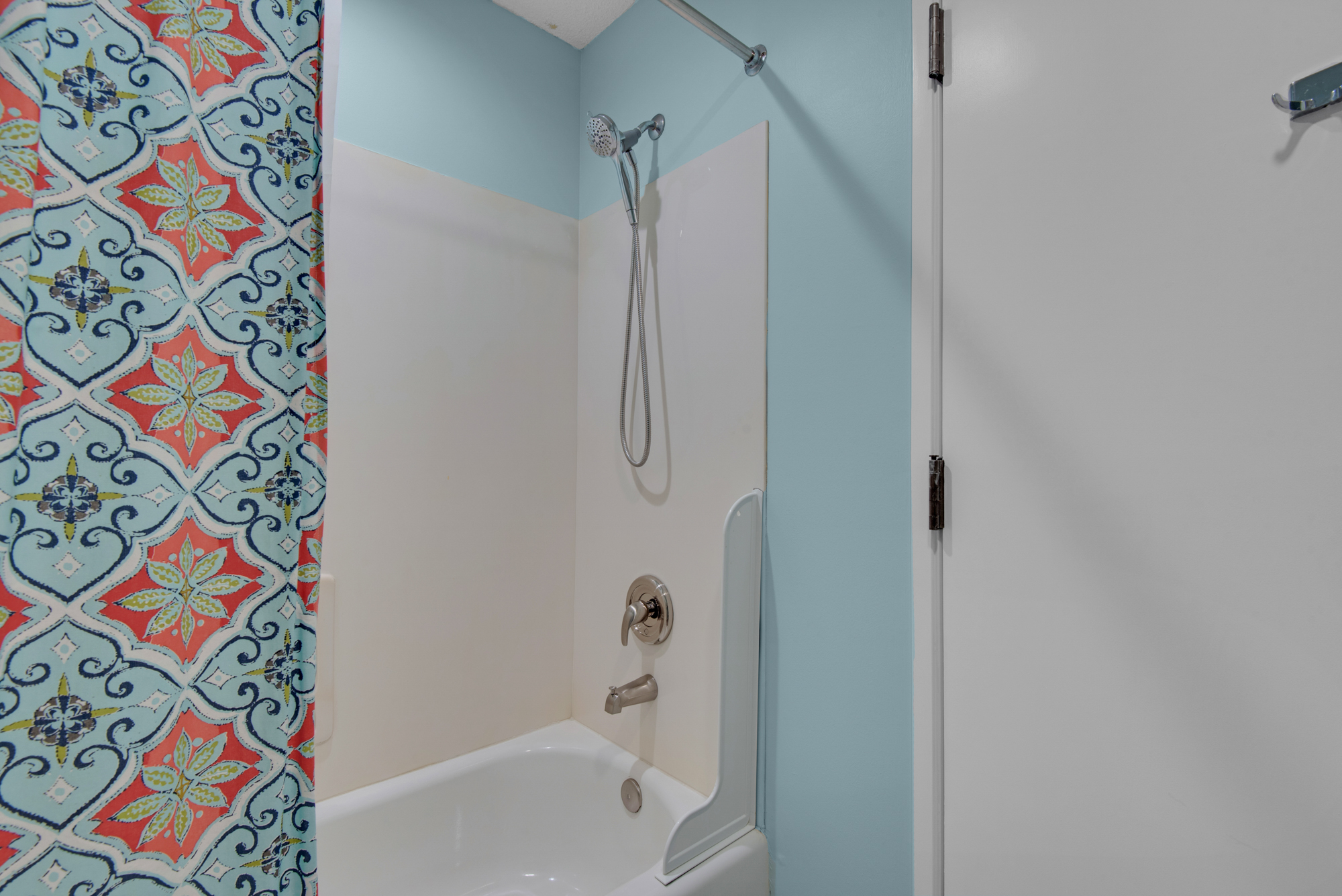 Front bathroom tub and shower; this bathroom is scheduled for an update in late 2026.