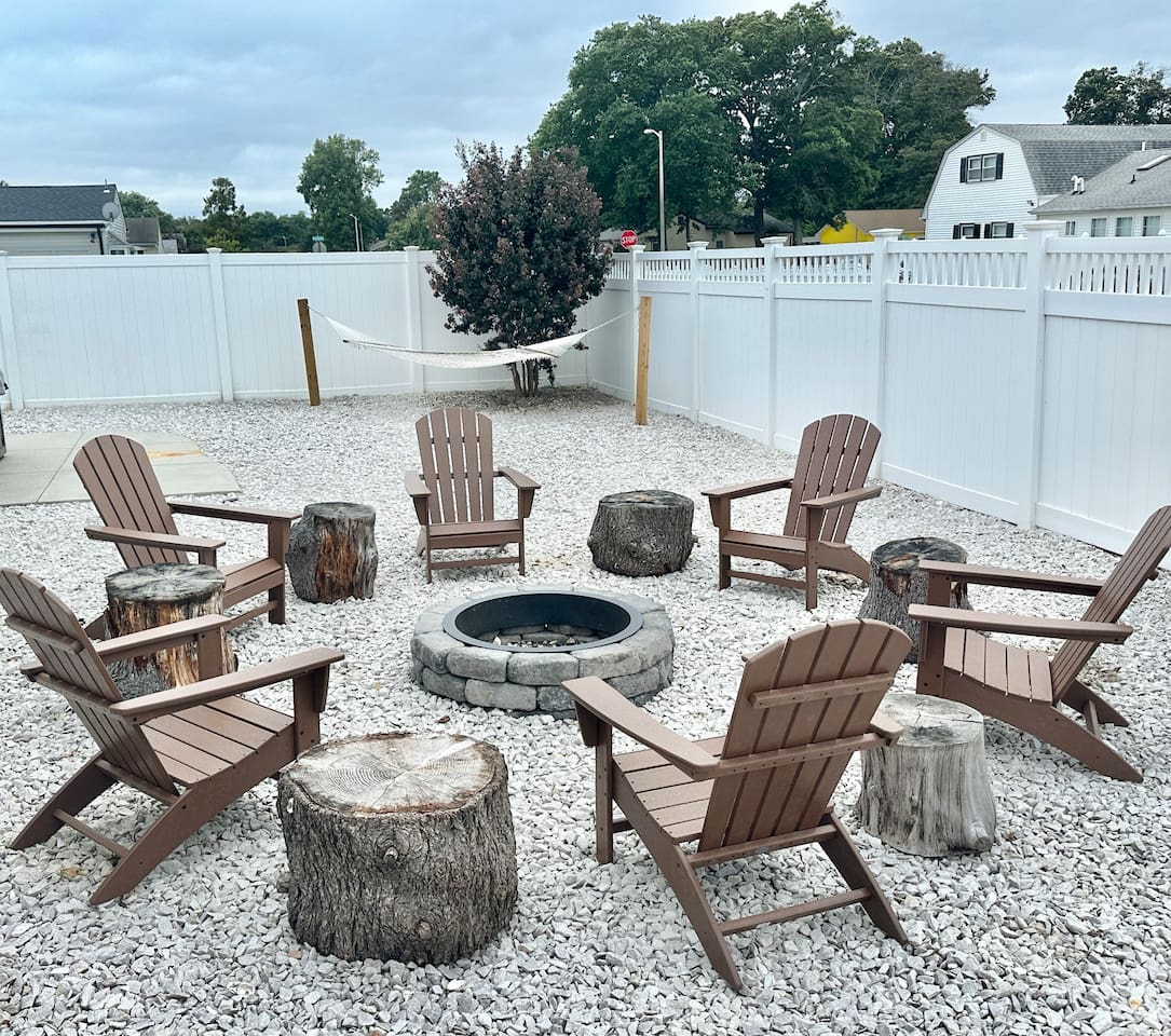 Gather around the stone fire pit in our spacious, fenced-in backyard for the ultimate evening under the stars. You can enjoy s'mores in comfortable Adirondack chairs or relax in the hammock nearby.