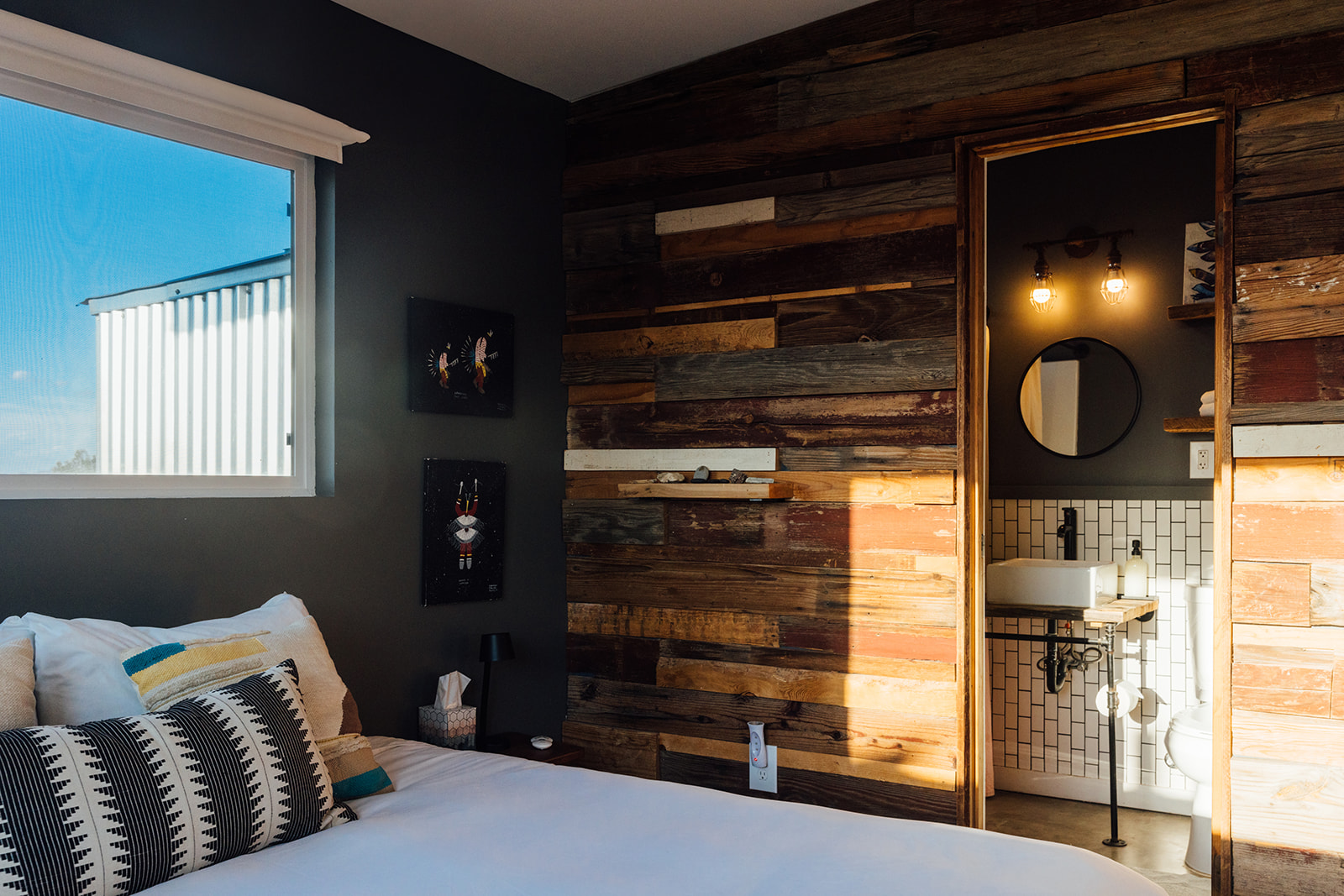 Beautiful bedroom wall with decor accents and direct access to the modern bathroom, offering comfort and convenience.