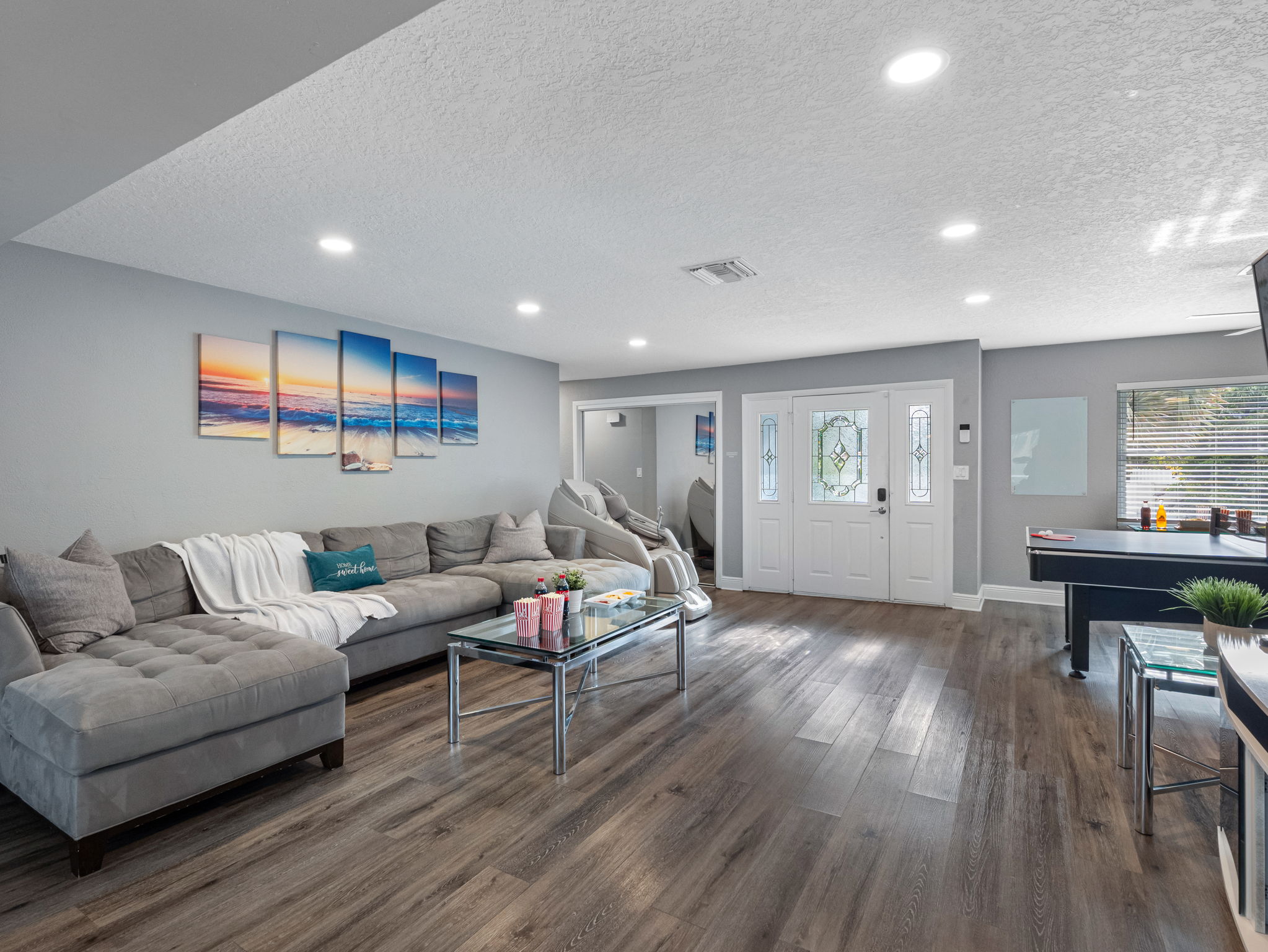 A roomy and inviting sectional provides plenty of seating for family movie nights, board games, or casual hangouts.