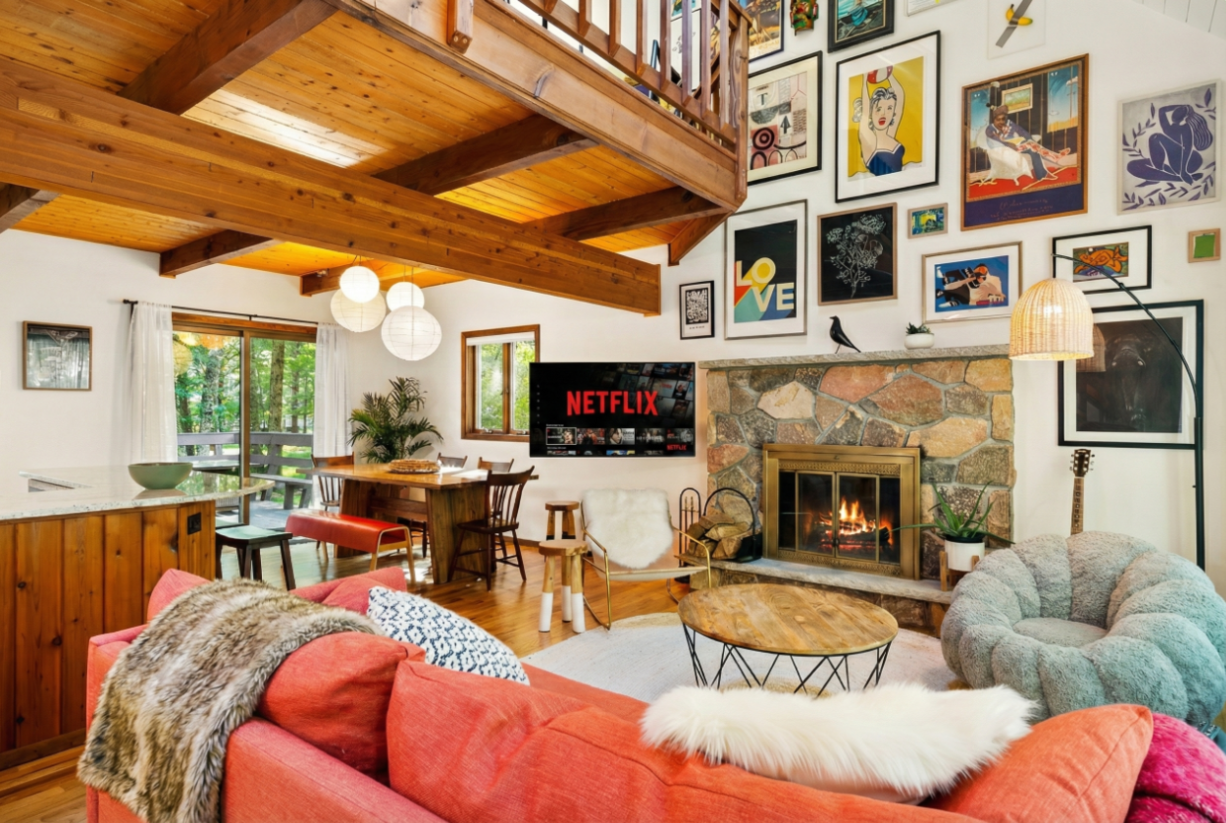 Living area with couch, comfy chairs, and gallery art wall