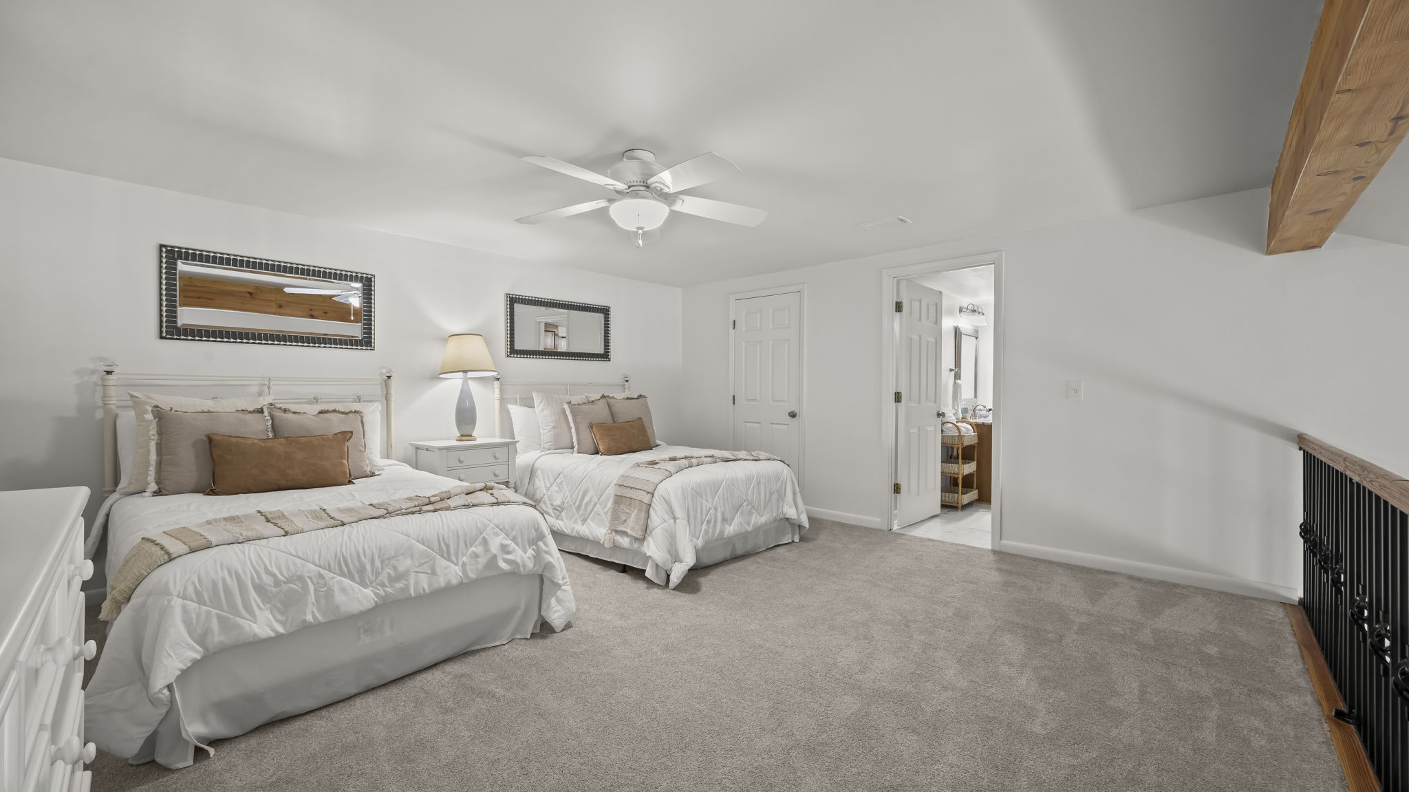 Relax in the spacious guest loft of our Cotton Bayou condo, featuring two double beds, a smart TV for entertainment, and a cozy atmosphere. Perfect for family or friends to unwind after a day at the pool or out on the water.