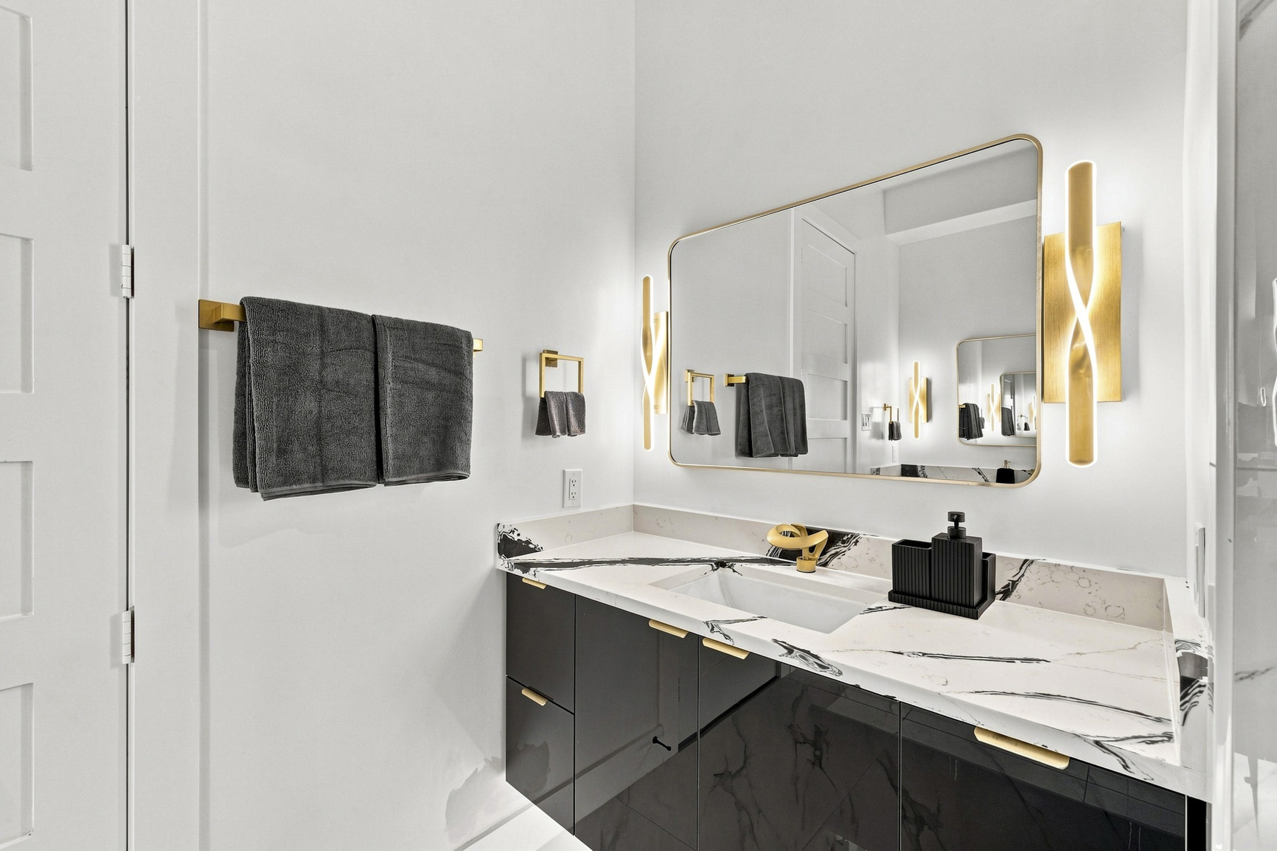 Indulge in luxury with elegant finishes and ambient lighting in this chic bathroom!