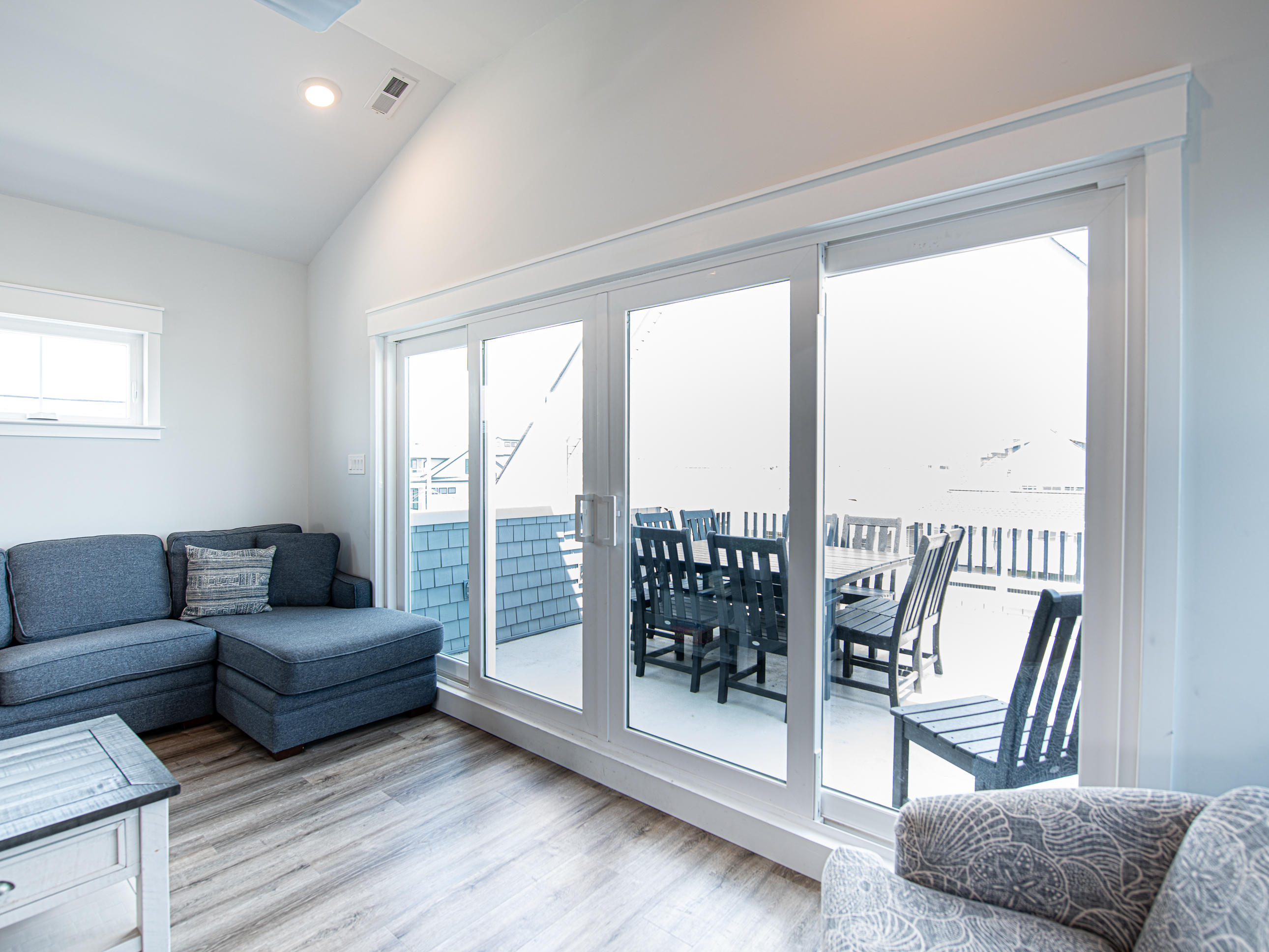 Living area looking out to balcony w/ ocean views