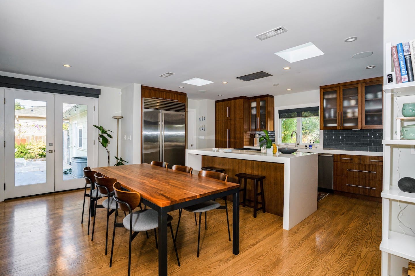 Fully stocked chef's kitchen with 8 person dining table and two person island seating.