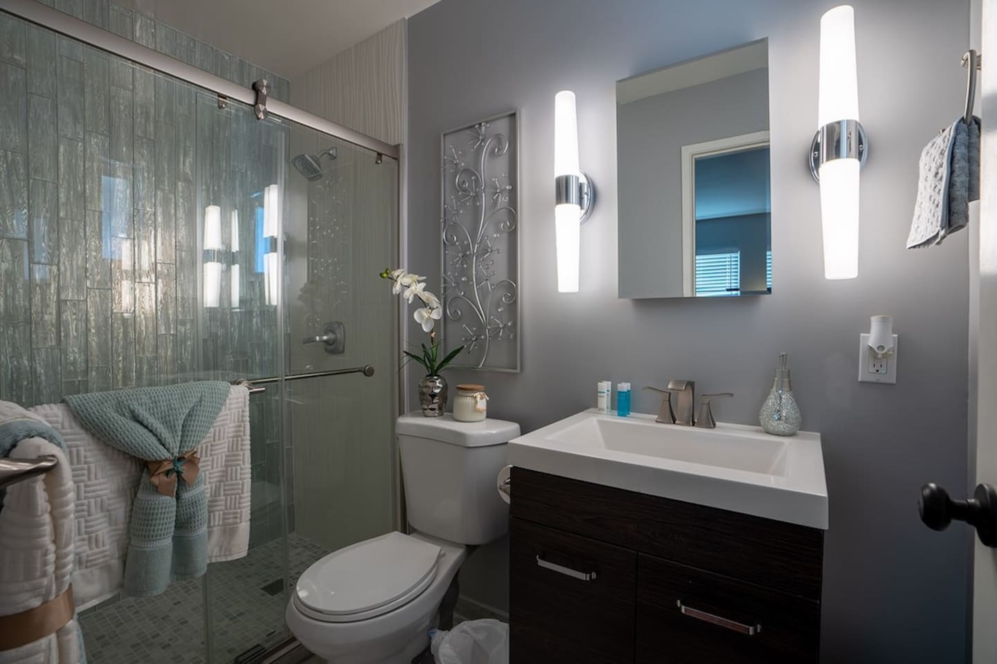 A bathroom with a sink, toilet, and shower, ready for a day of adventure.