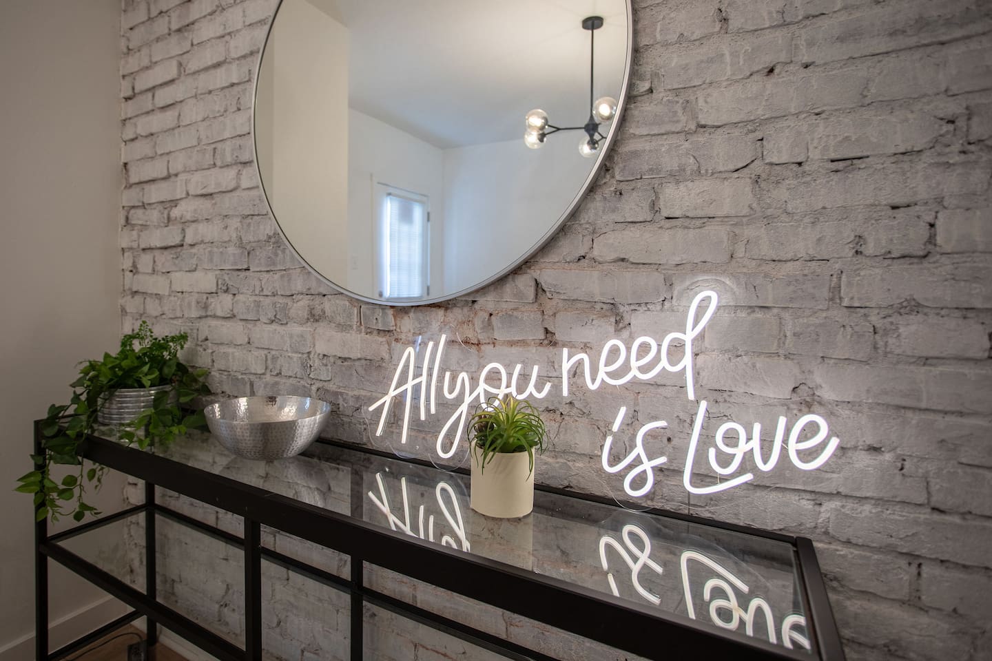 Large mirror with elegant wall décor, creating a striking focal point that enhances the room's sense of space and style.