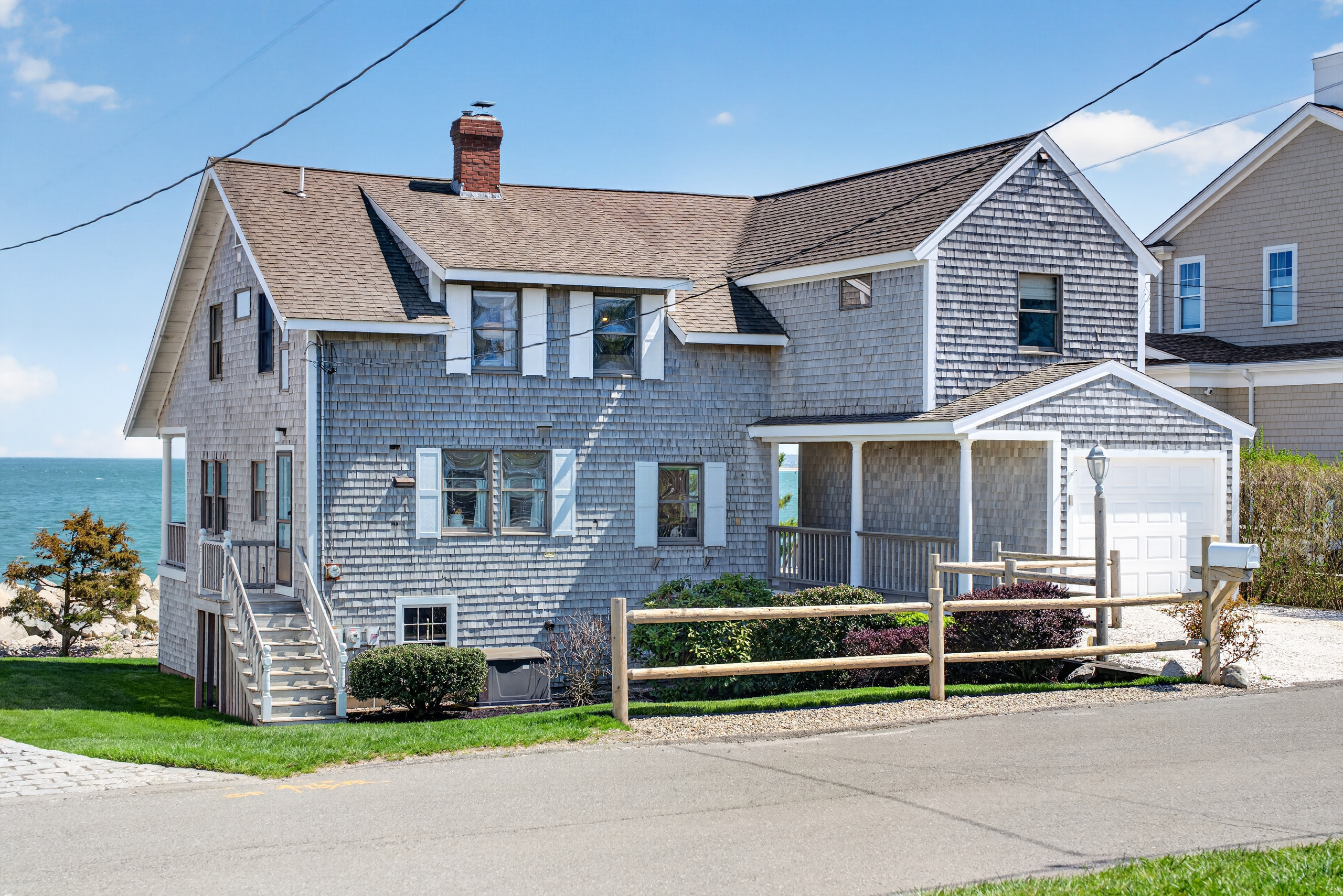 Charming seaside home featuring classic coastal architecture, a spacious lawn, and direct proximity to the shoreline—perfect for enjoying peaceful oceanfront living. 🌊🏡