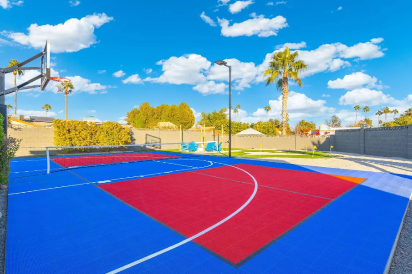 Painted red and blue zones turn this court into a flexible space for basketball, volleyball, or pickleball.
