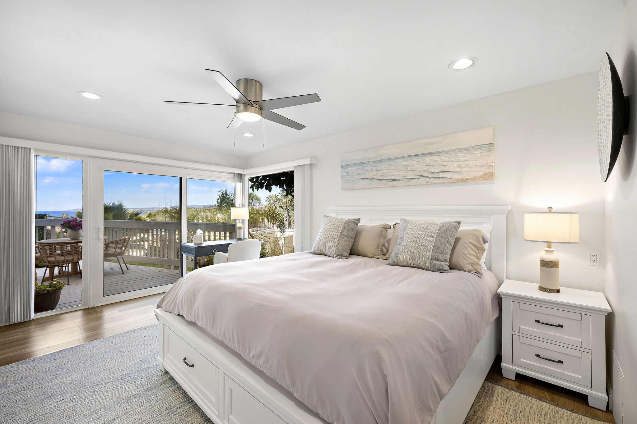 Drift off in the peaceful primary bedroom, featuring luxury bedding and calming coastal tones for a great night’s sleep.