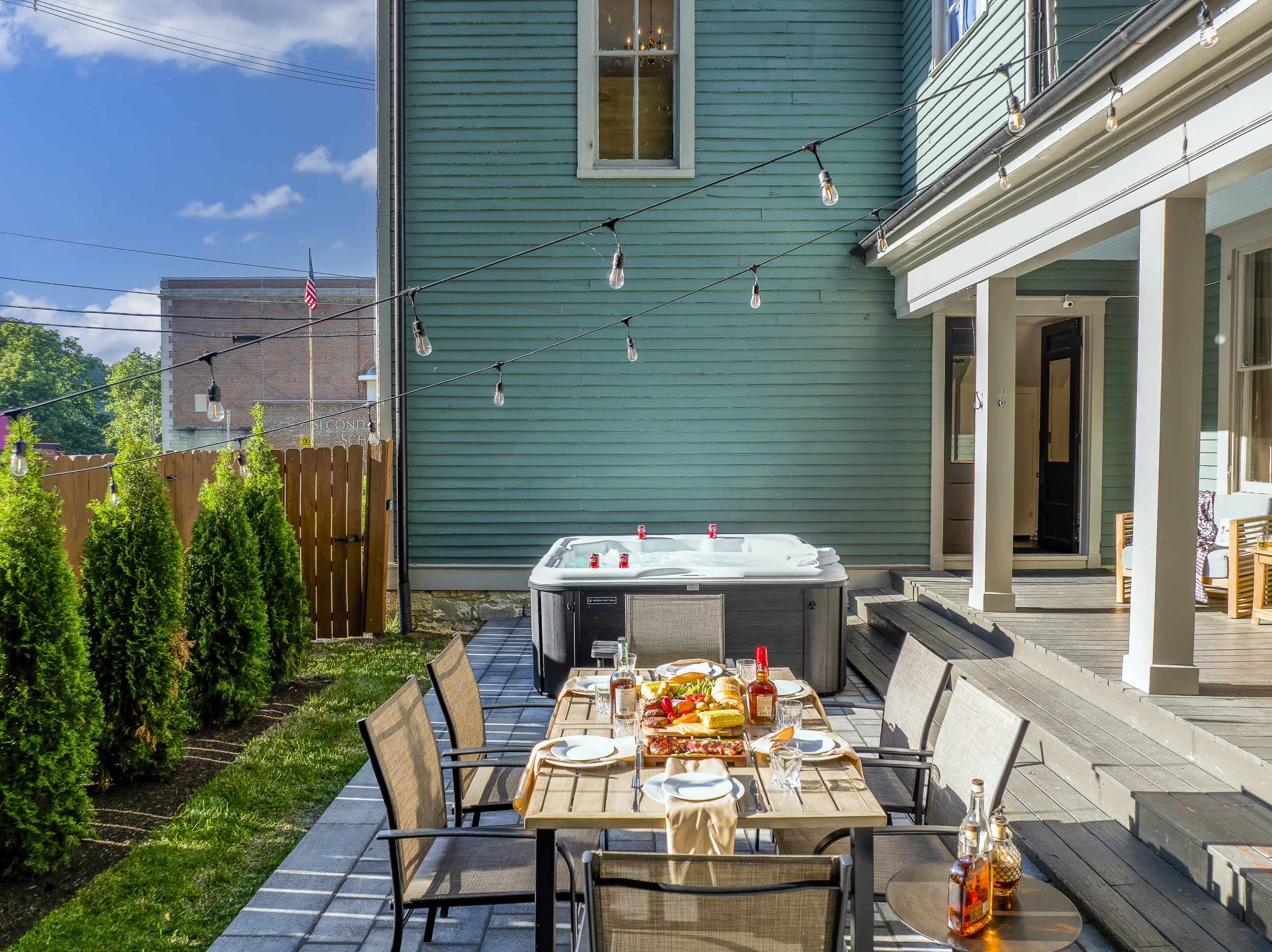 The private back patio brings outdoor dining and hot tub soaking side by side under open Kentucky sky.