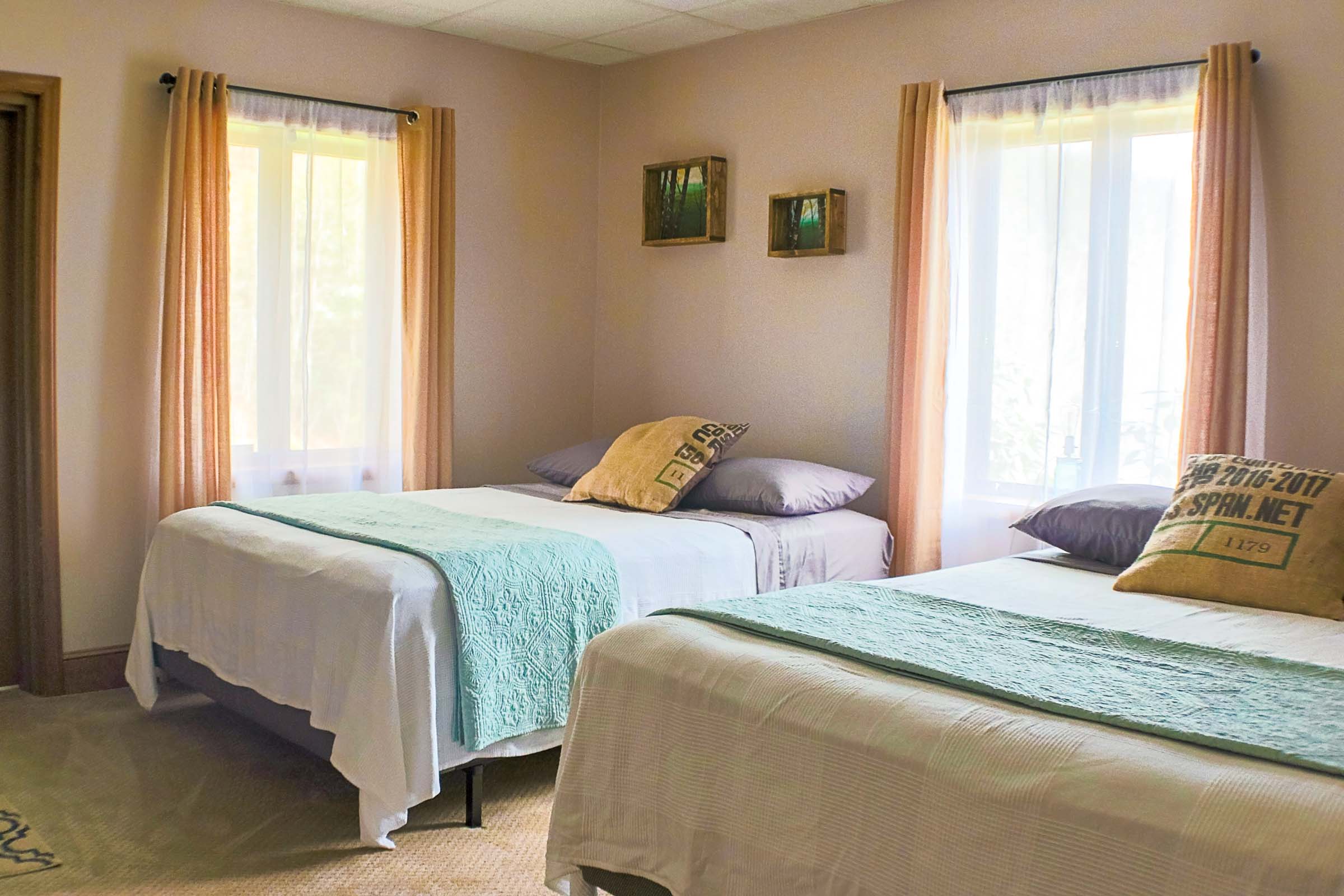 Lower level bedroom that features two queen beds