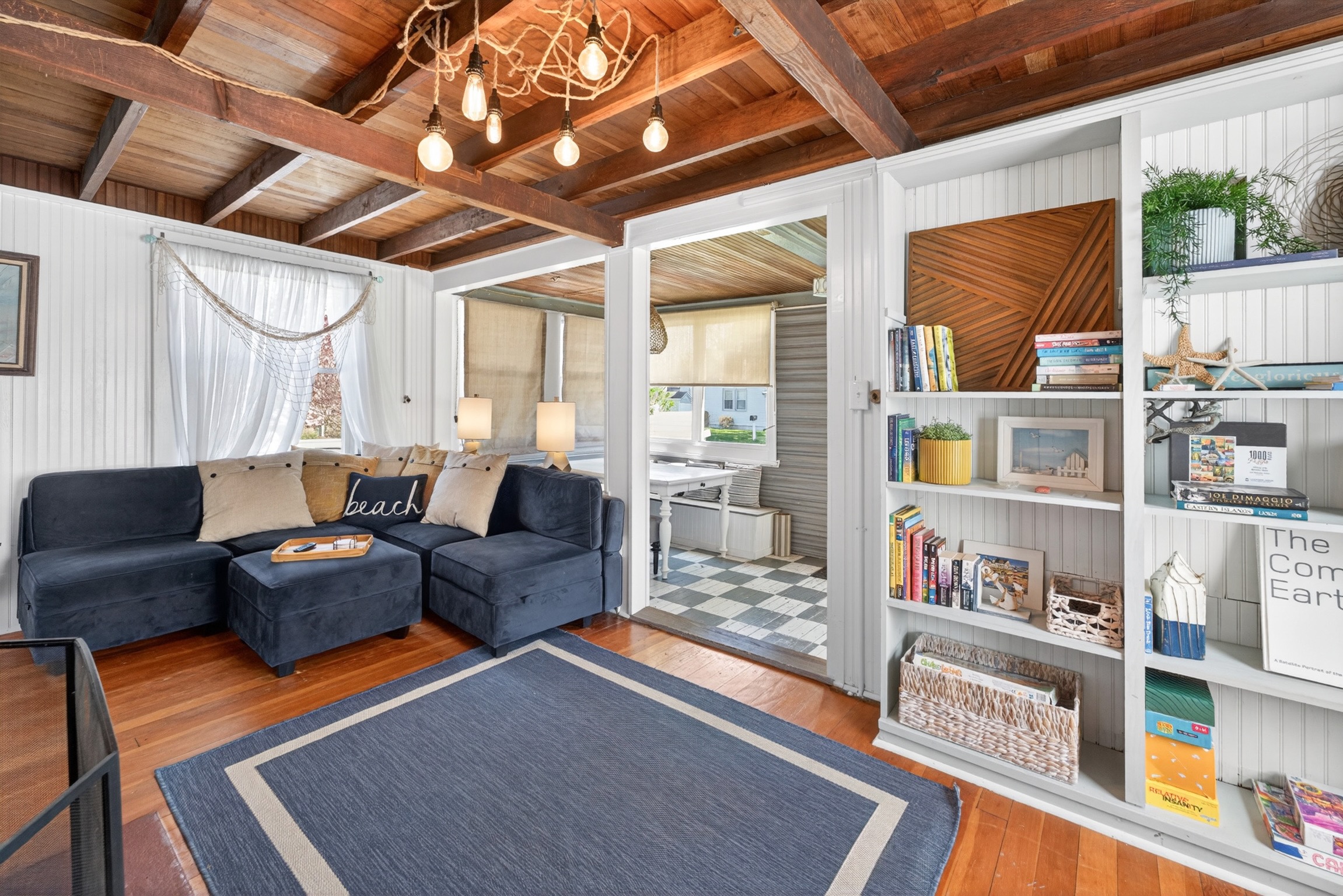 Comfortable living room featuring an abundance of games, books, cozy seating, and a smart TV for relaxing nights in.