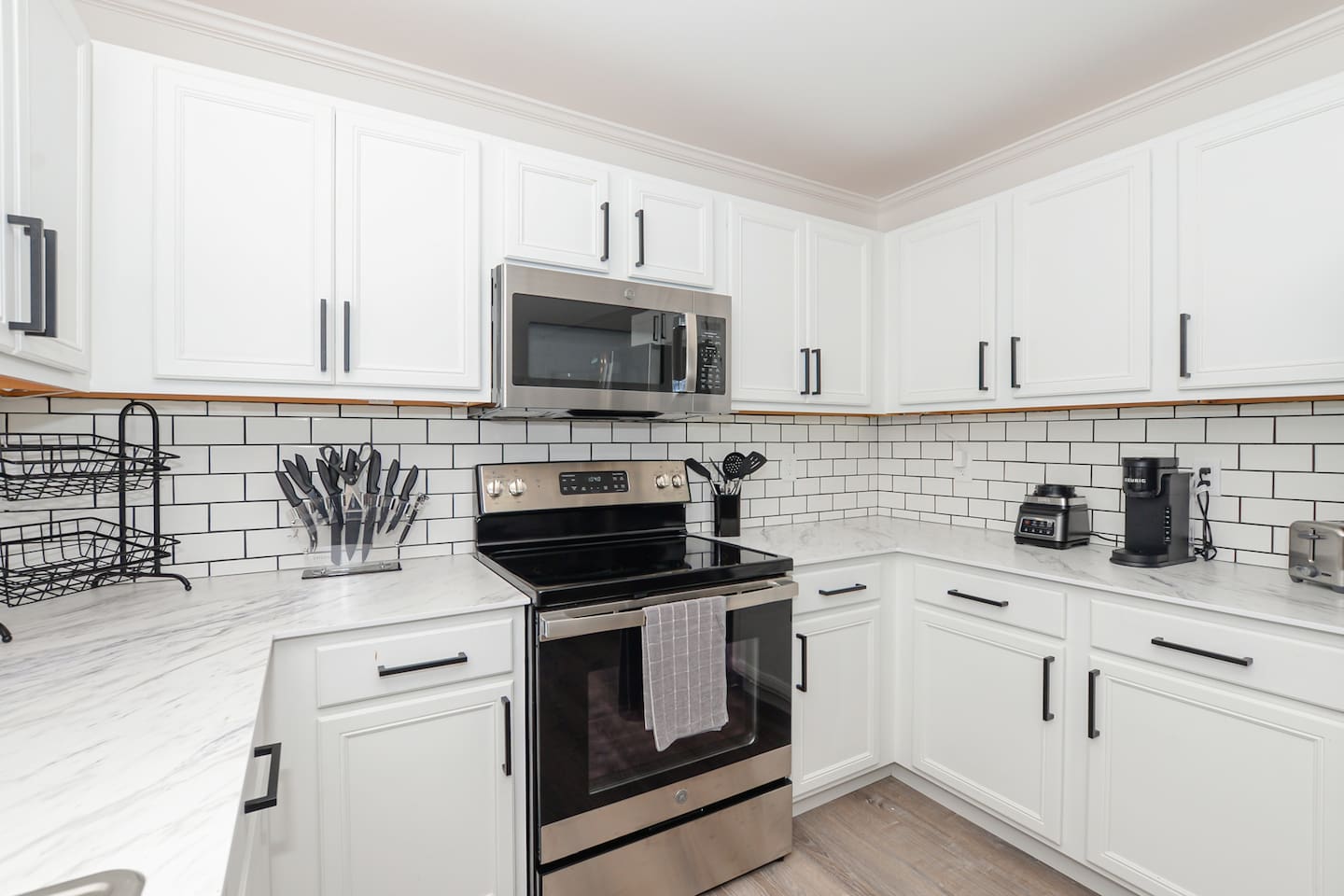 Fully equipped kitchen with modern appliances and ample space for cooking and dining.