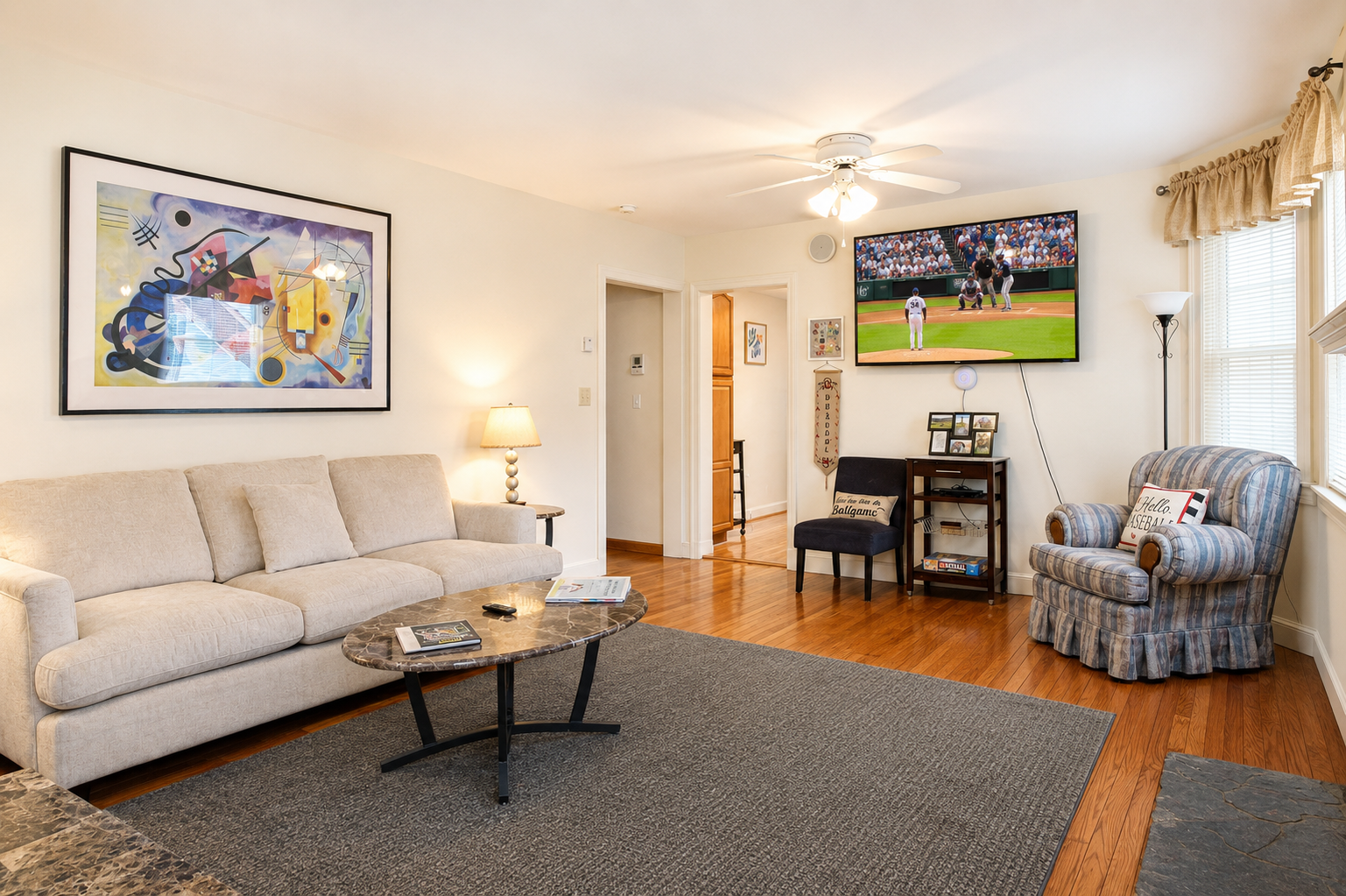 Living Room.  There are hardwood floors throughout the unit, with a granite tile floor in the fully tiled bathroom