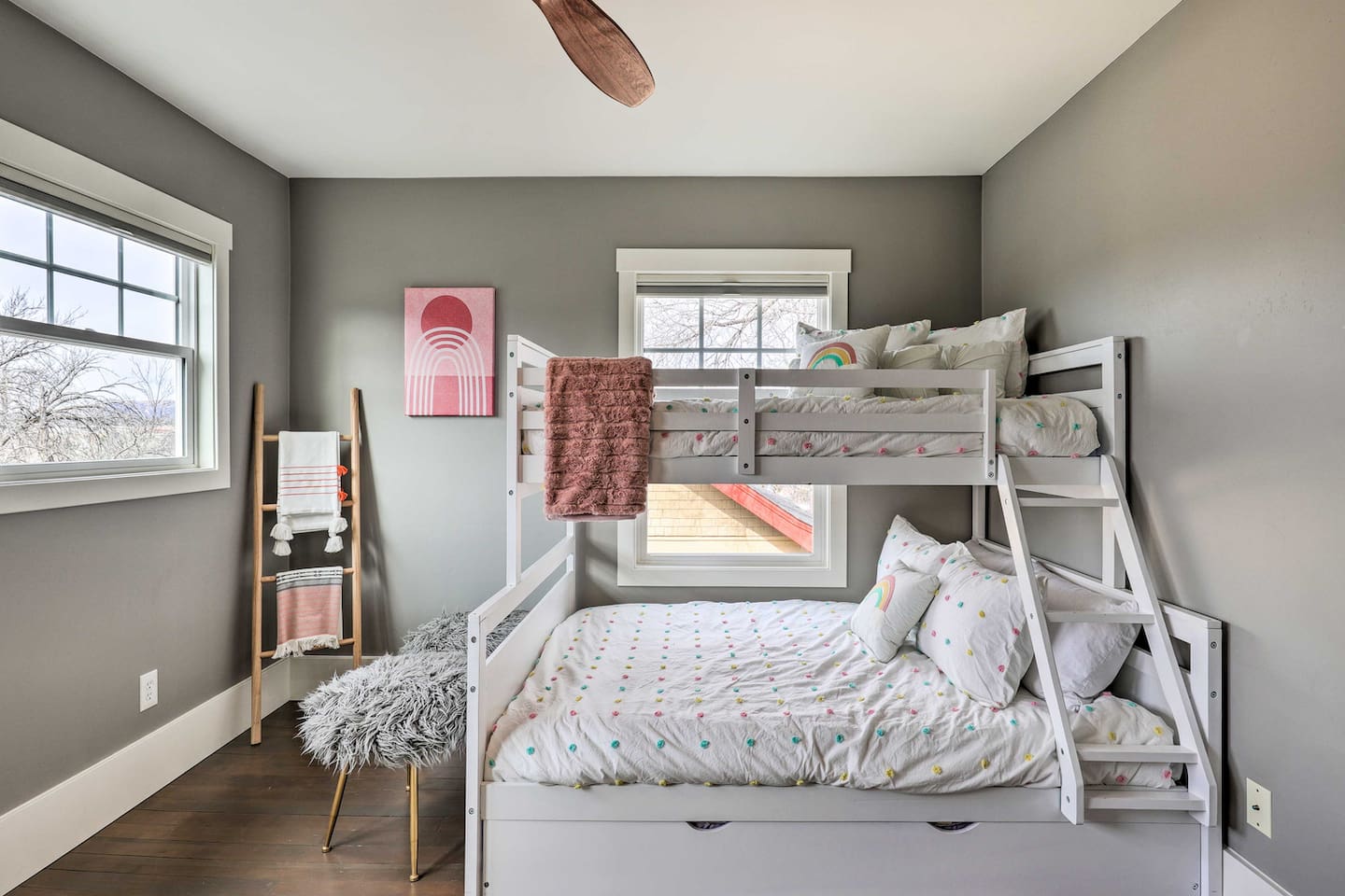 A playful retreat for the little ones, with a trundle bunk that sleeps the whole crew and rainbow accents that keep bedtime fun.