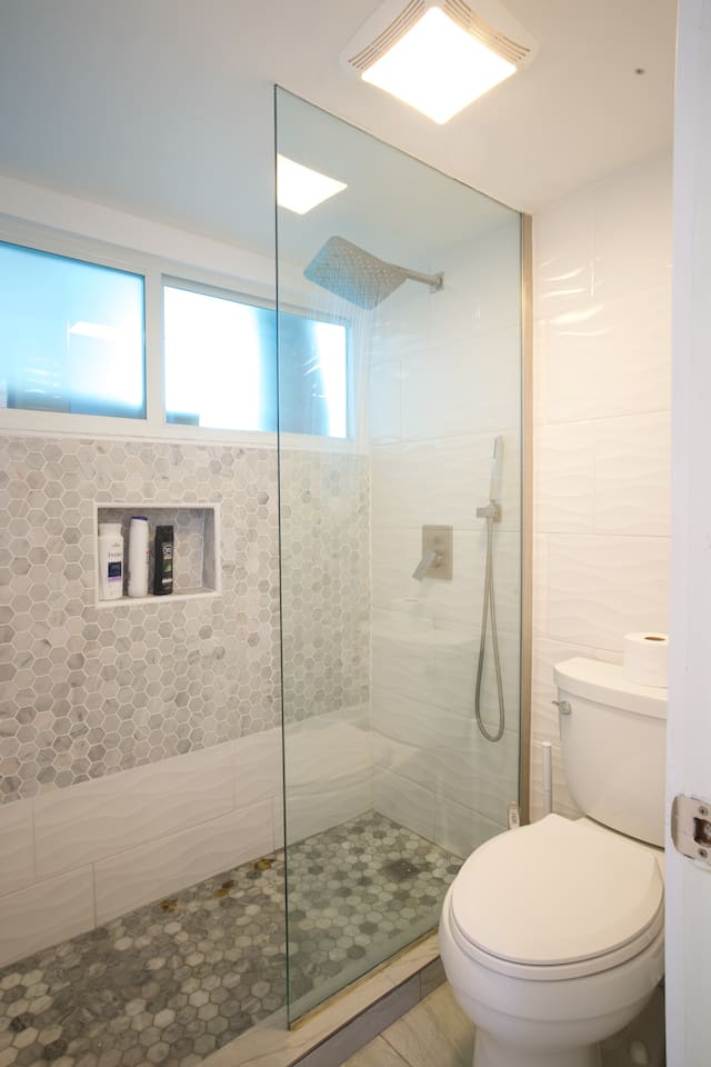 Remodeled bathroom with walk in shower and rain shower head