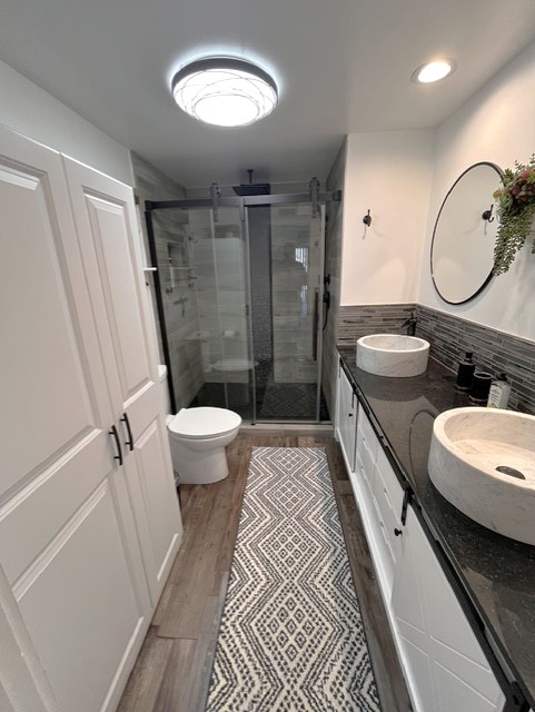 Walk-in shower with rain and handheld heads, instant hot water never runs out.