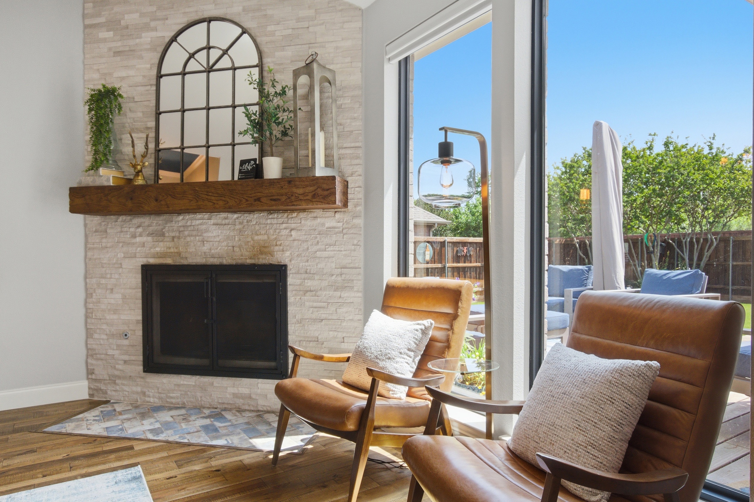 Comfortable seating by the wood-burning Fireplace with views straight out to the Backyard through tall sliding doors.
