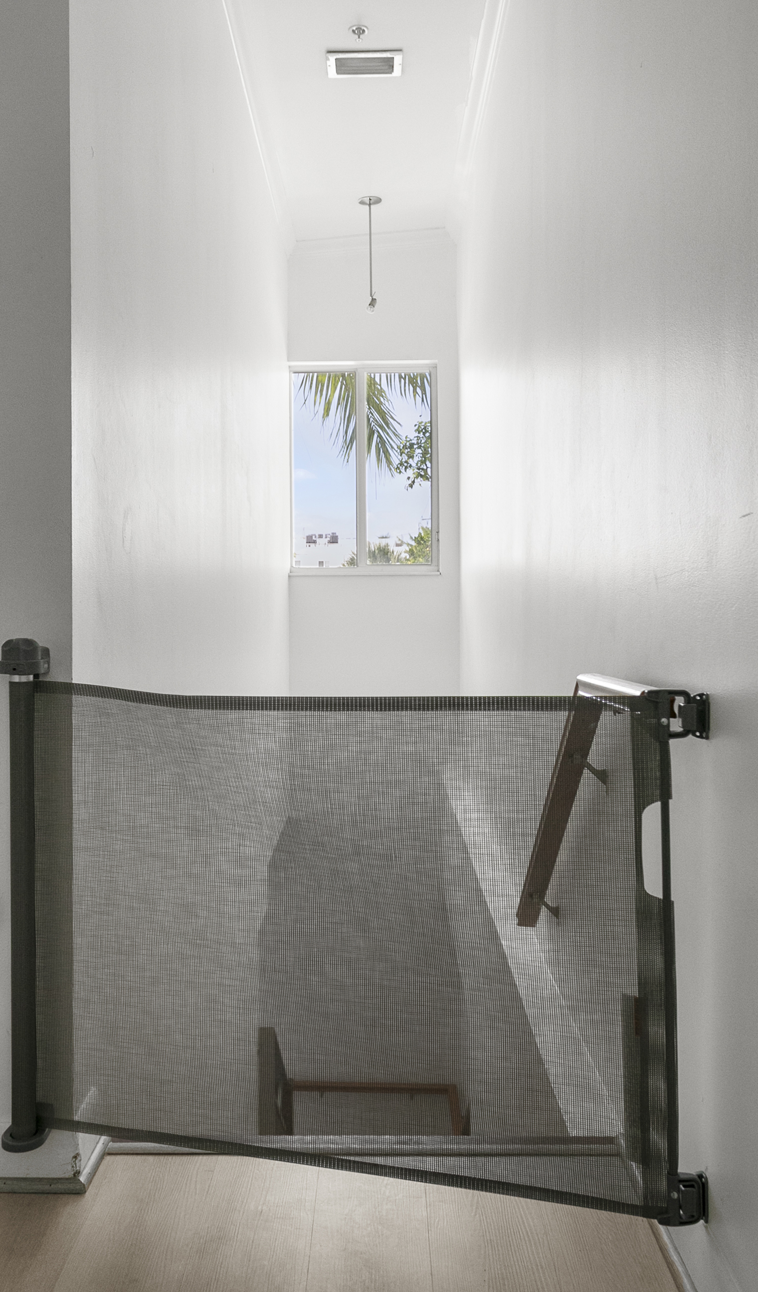 Retractable child gates at stair landings