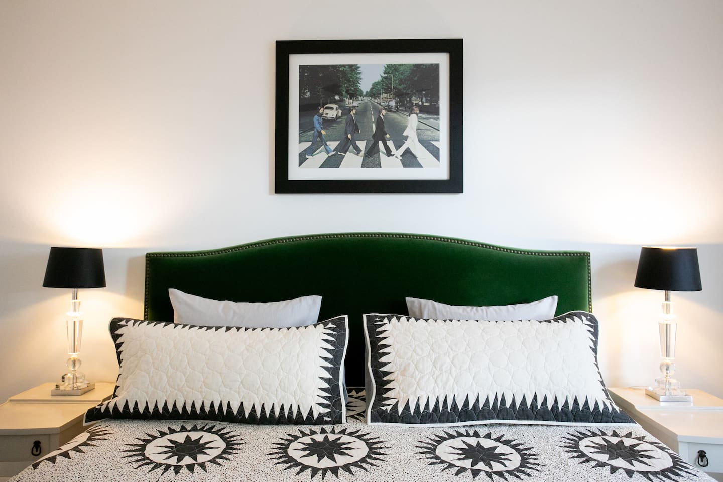 Primary bedroom with a king bed, plush mattress, soft cotton linens, and blackout shades