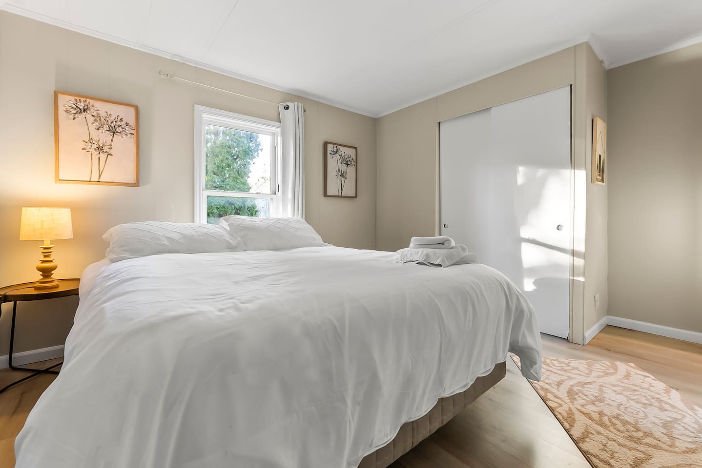 Bedroom two features a comfortable setup with closet space and serene decor.