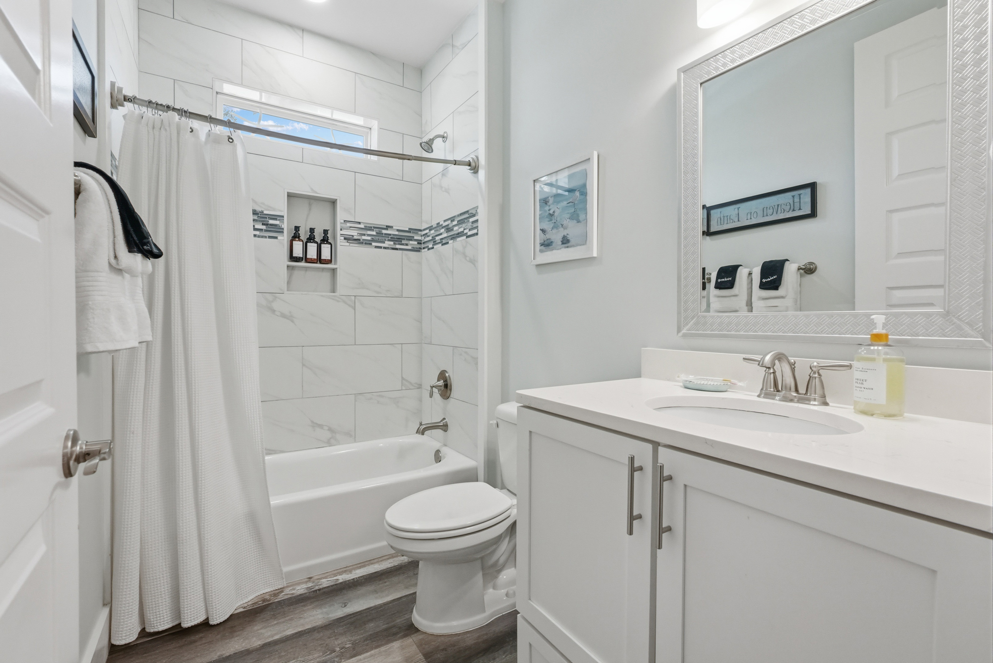 The second bathroom has a bath and shower and dispensers for kids or adults.