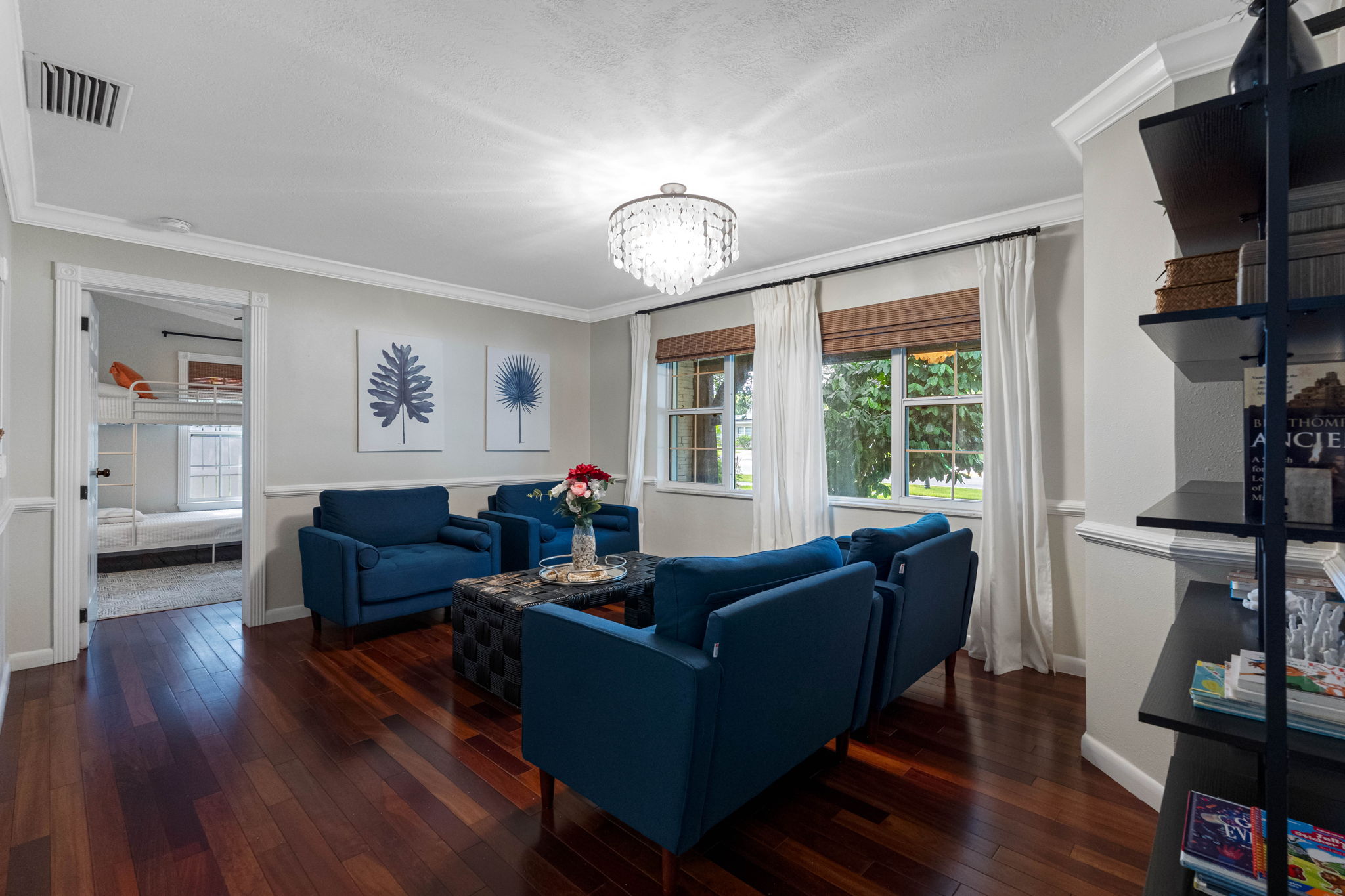 A stylish chandelier illuminates the room, adding a touch of elegance to this inviting gathering area.
