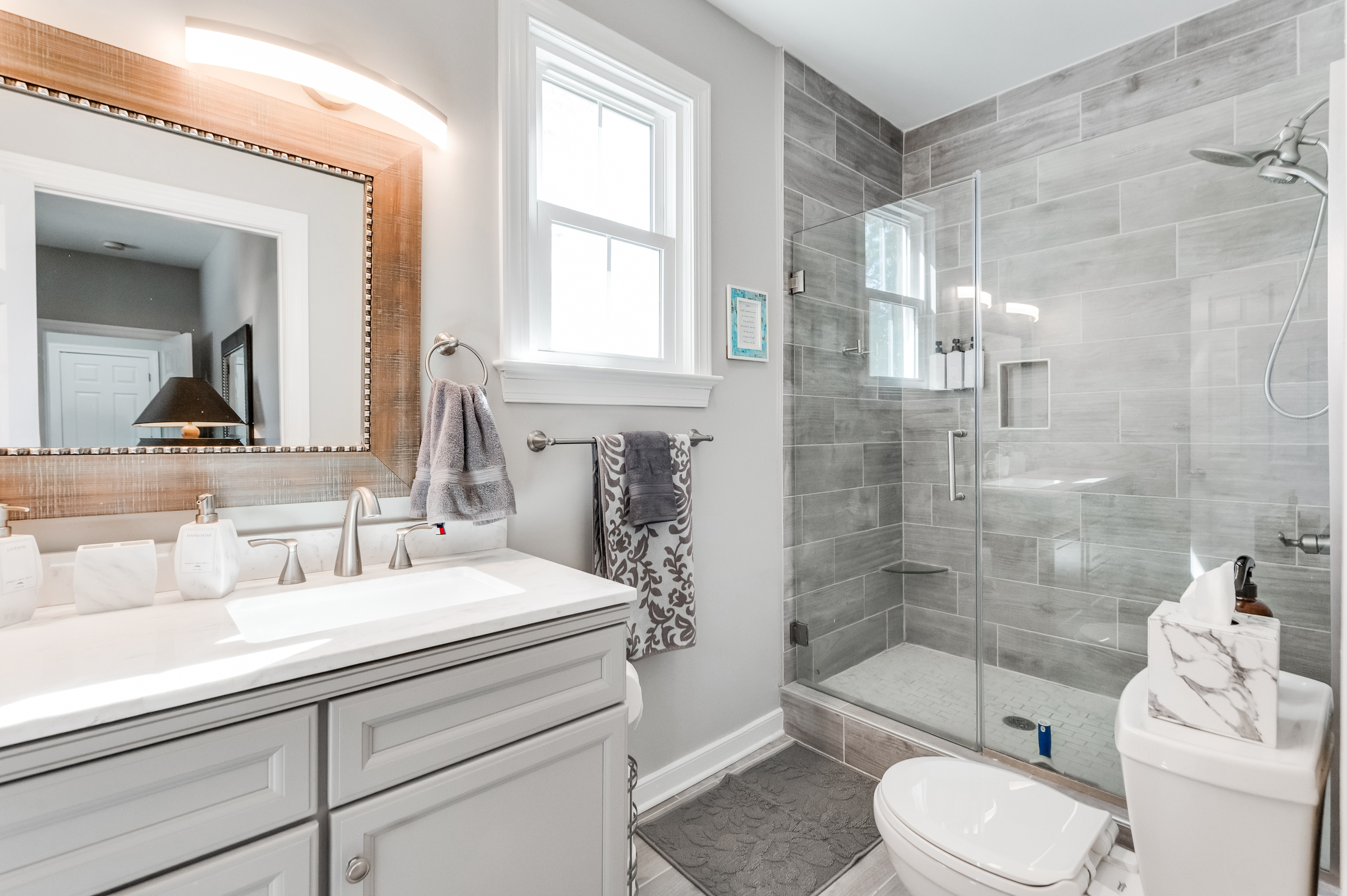 Ensuite Bathroom 2: Bright space with elegant fixtures, a walk-in shower, and stylish decor awaits!