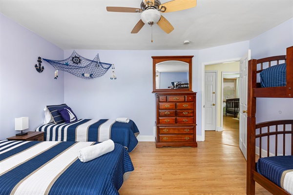 Set sail for adventure in our charming nautical-themed kids' room! With 2 side-by-side twin beds and a twin-over-twin bunk bed with a pull-out trundle, little sailors can enjoy their own marit