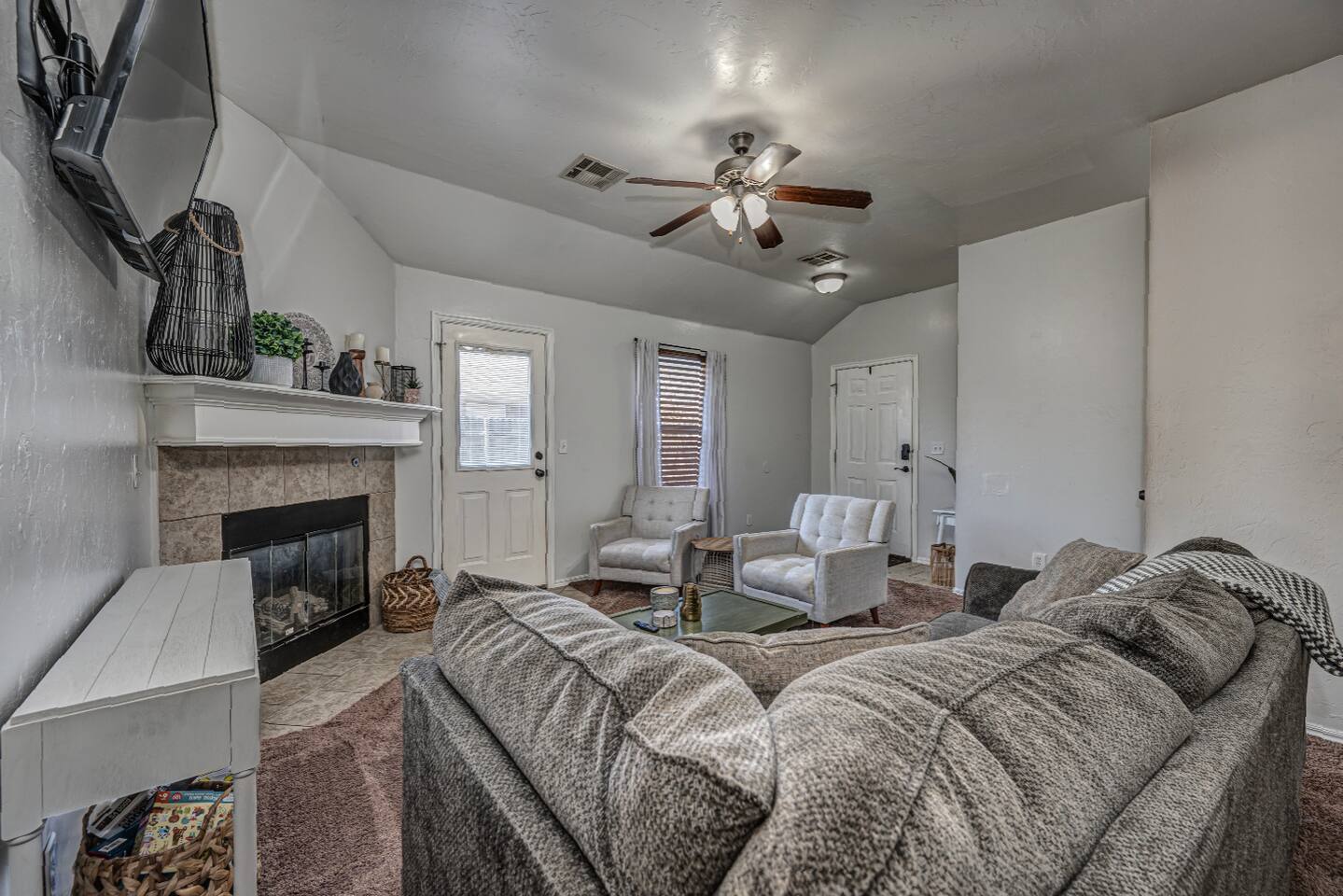 Inviting living room with smart TV, fireplace, and plenty of comfort.